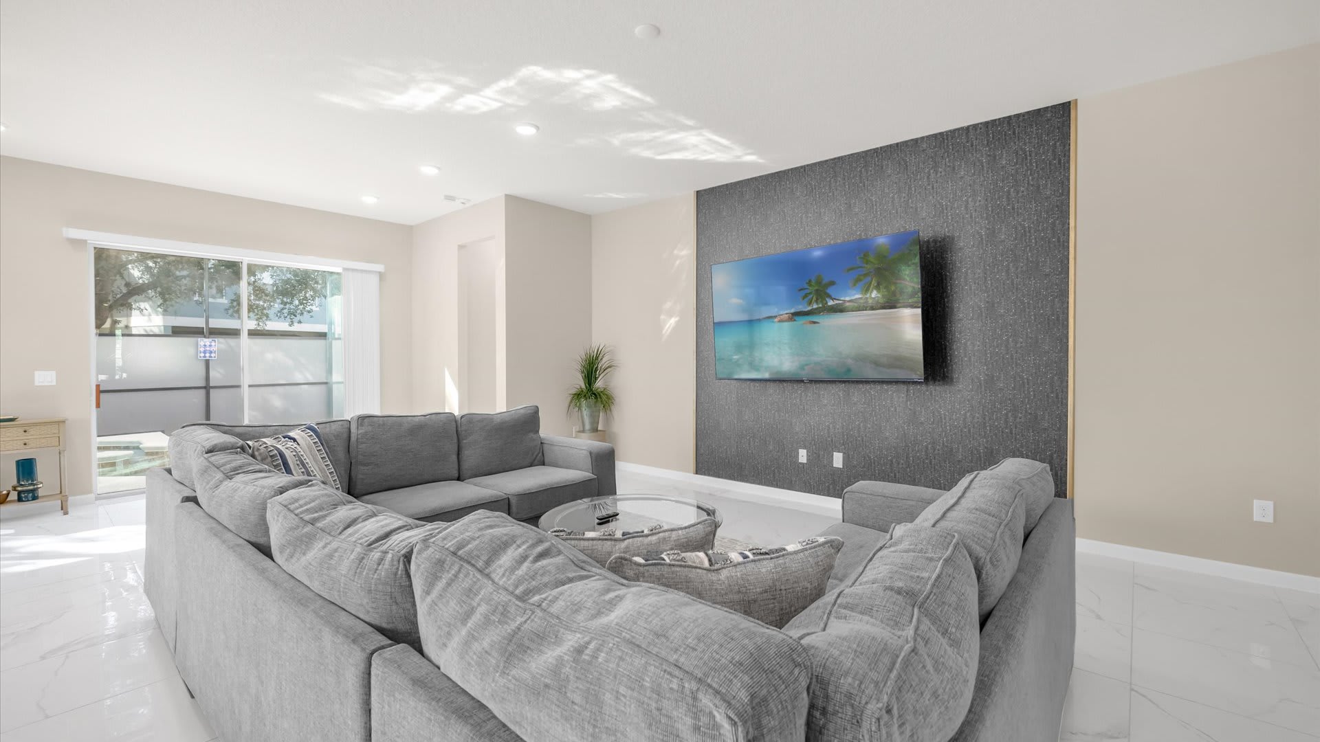 Spacious Living Room – Modern open-plan living area with plush seating and a large smart TV.