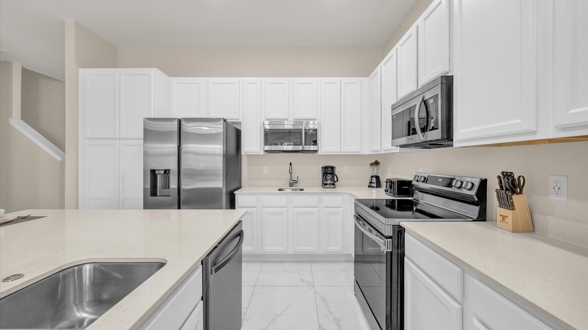 Fully Equipped Modern Kitchen – Sleek stainless-steel appliances, double fridges, and ample prep space.