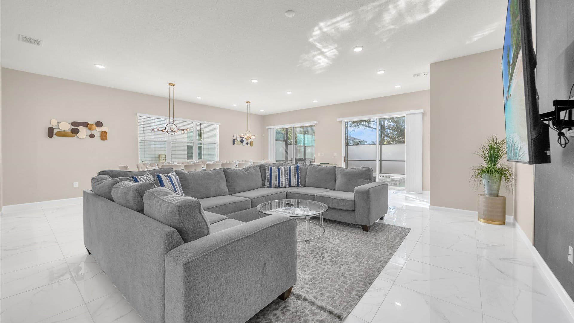 Spacious Living Room – Modern open-plan living area with plush seating and a large smart TV.