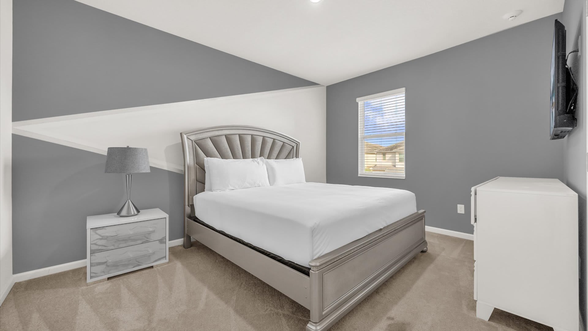 Bedroom 1 – King Suite – Stylish king bed, ensuite bathroom with smart TV.