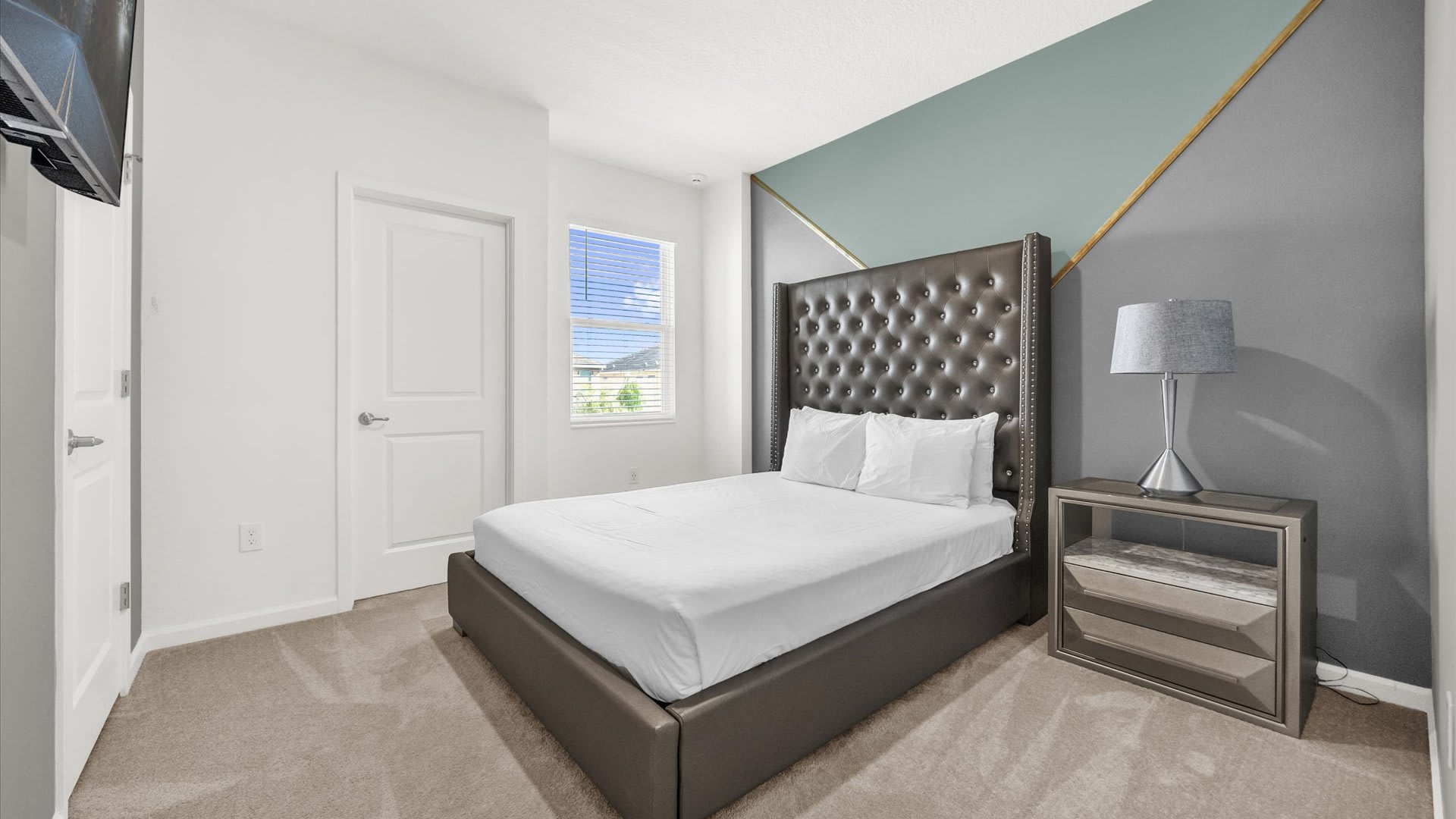 Bedroom 2 – Queen Suite – Elegant décor and ensuite bath with smart TV and en-suite bathroom.