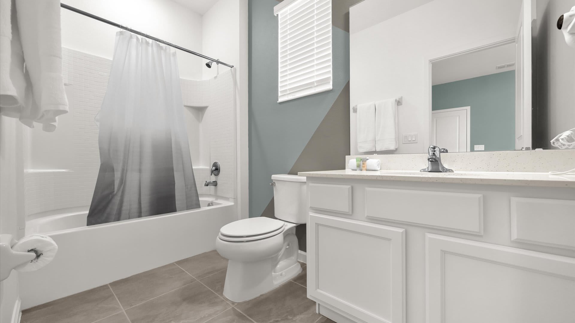 Modern Ensuite Bathroom – Sparkling clean with a bathtub and shower combo and contemporary finishes.