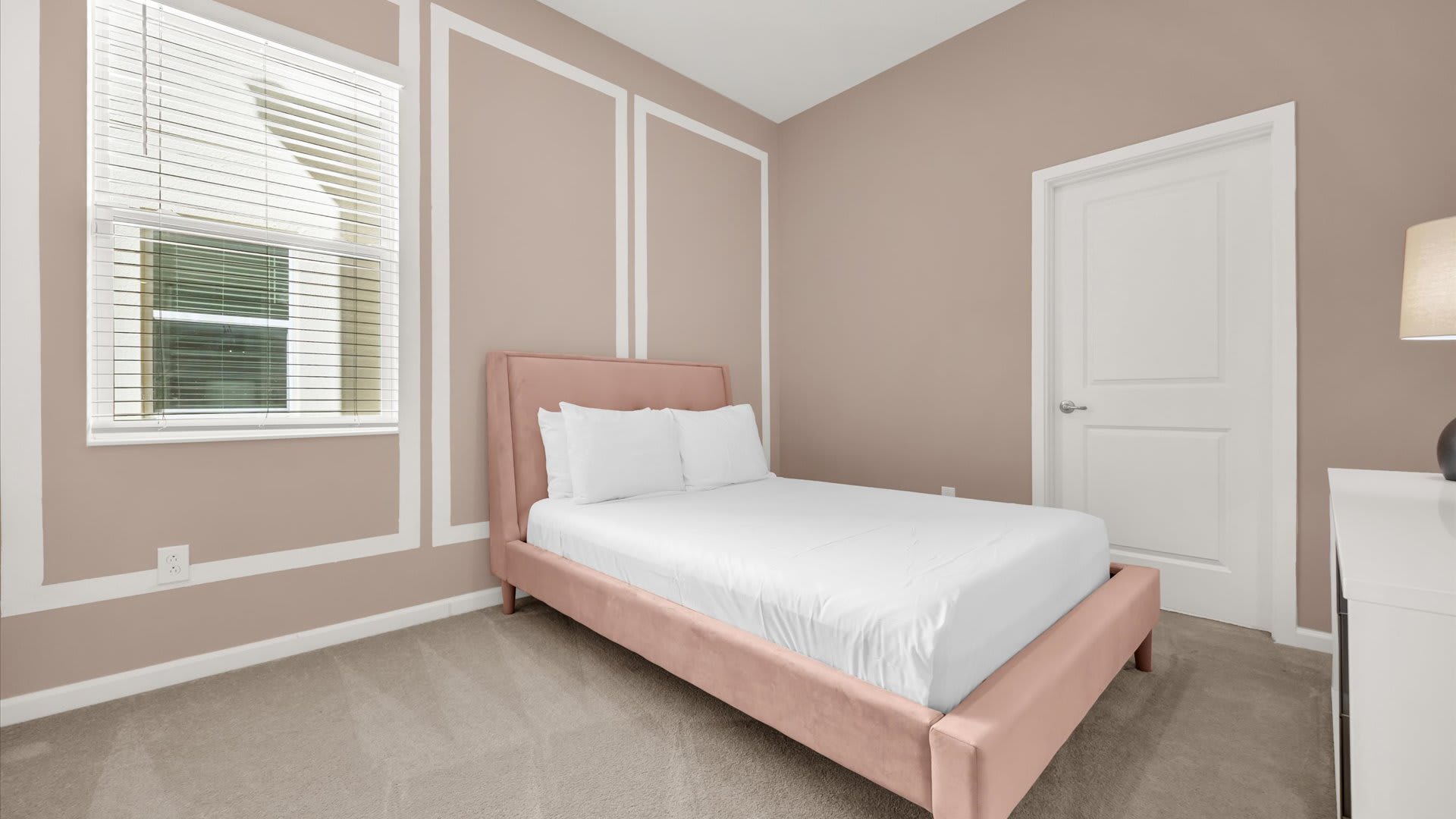 Bedroom 7 – Queen Suite – Chic space with calming pink walls and ensuite bathroom.