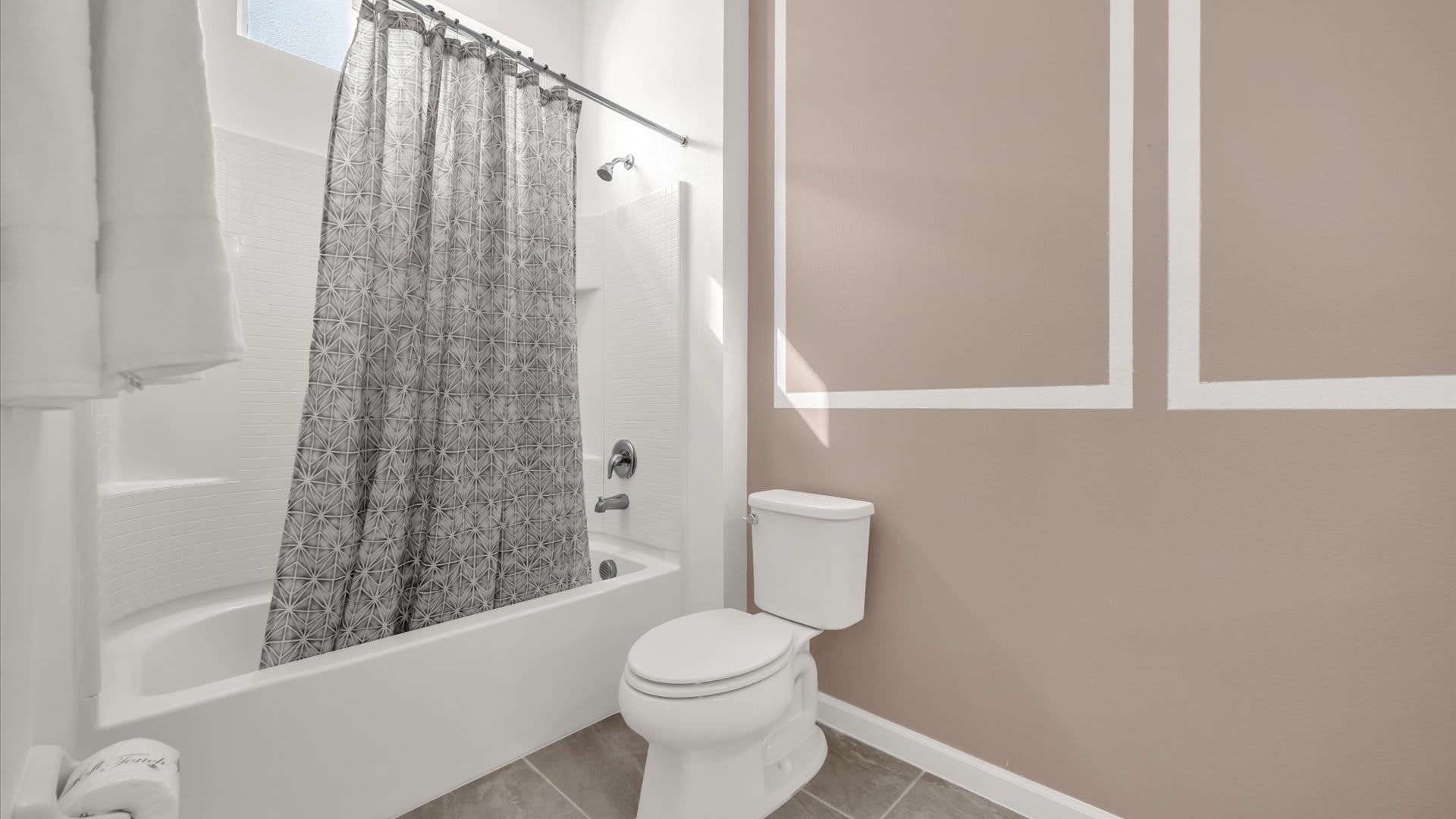 Modern Ensuite Bathroom – Sparkling clean with bathtub and shower combo.