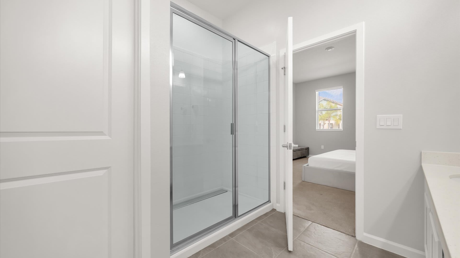 Modern Ensuite Bathroom – Dual basins with a standing shower and contemporary finishes.