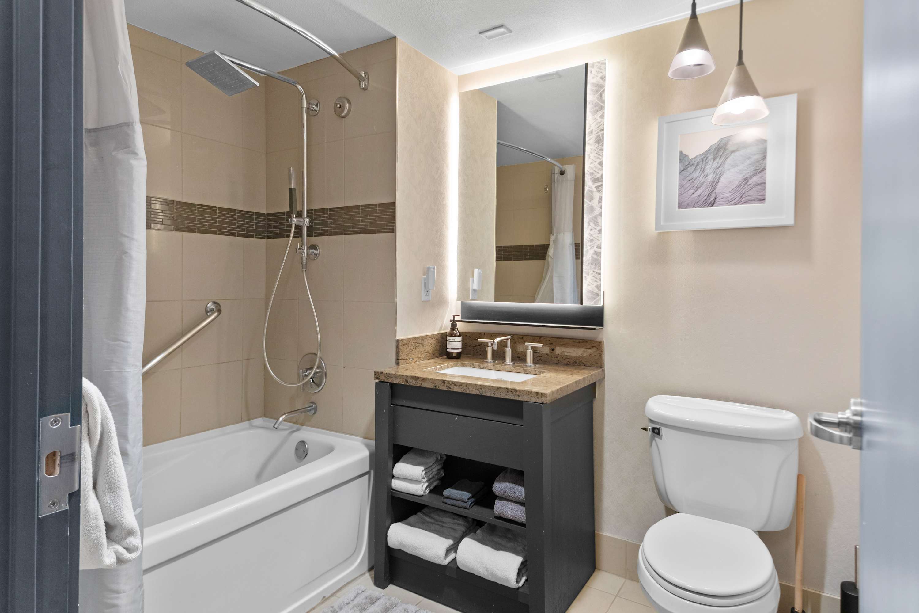 Full Bathroom w/ Large Tiled Tub, Stone Vanity & Backlit Mirror