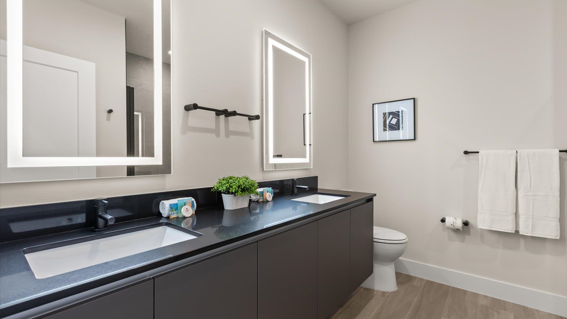 Contemporary en-suite master bathroom with dual basins and elegant finishes