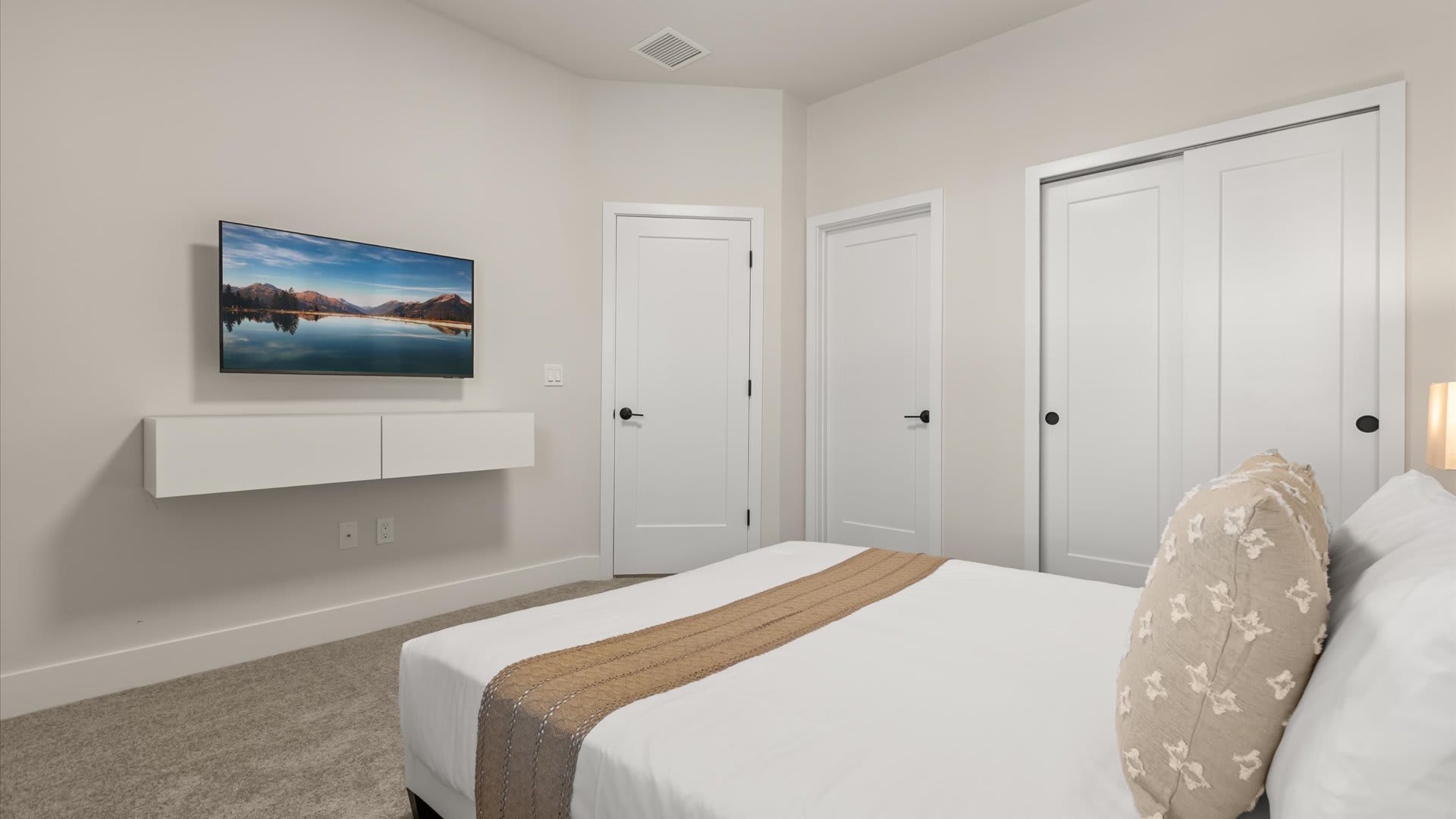 Peaceful Queen Bedroom with neutral tones and a smart TV