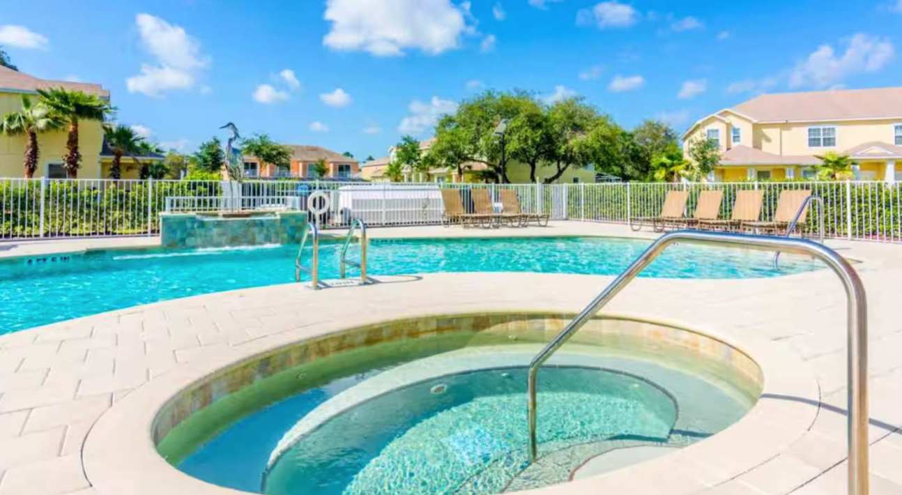 Resort Outdoor Community Pool and Hot Tub with Sun Loungers