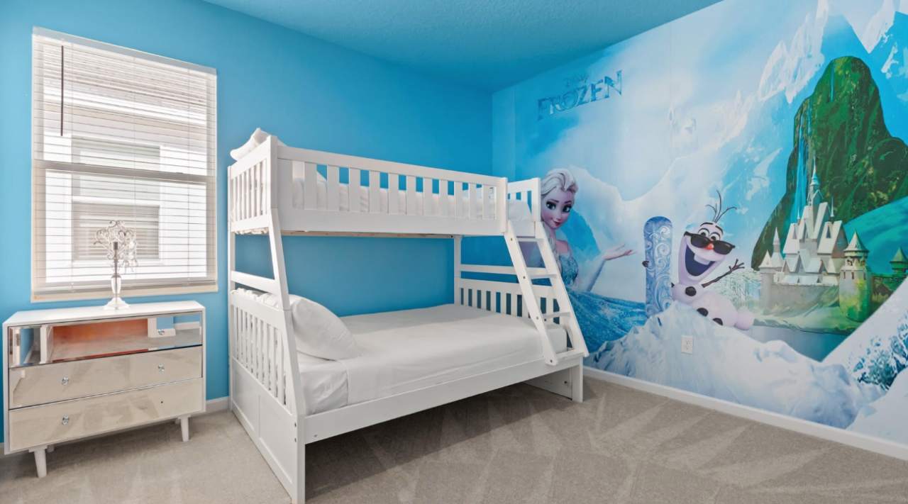Bedroom 12 – Frozen Themed Room: Bring the magic of Frozen to life in this icy blue bunk room — a dream come true for little adventurers.