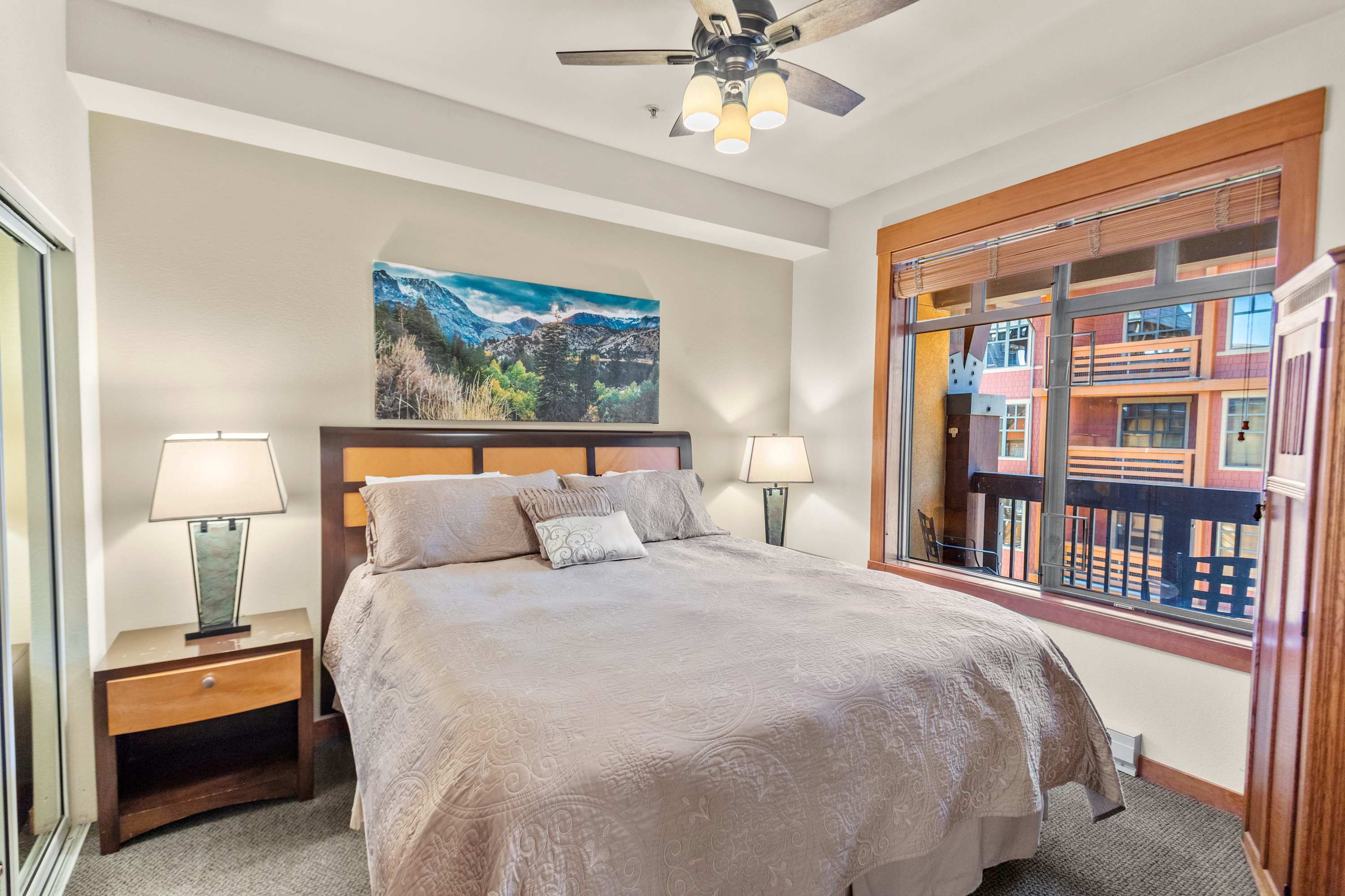 Luxurious King bed, ceiling fan, mirrored closet, and deck access.