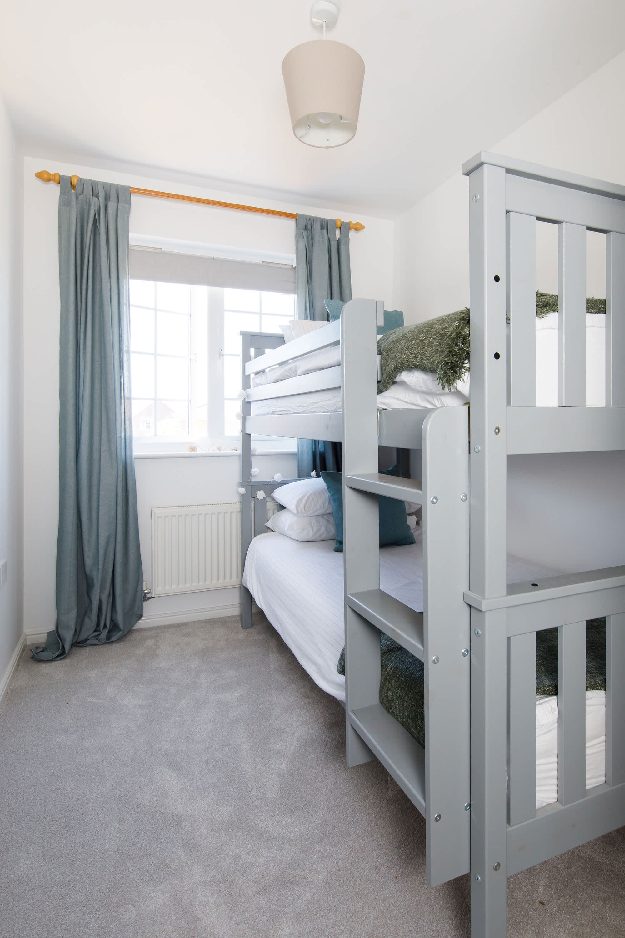 The bunk room has blinds and curtains to keep light out at night.