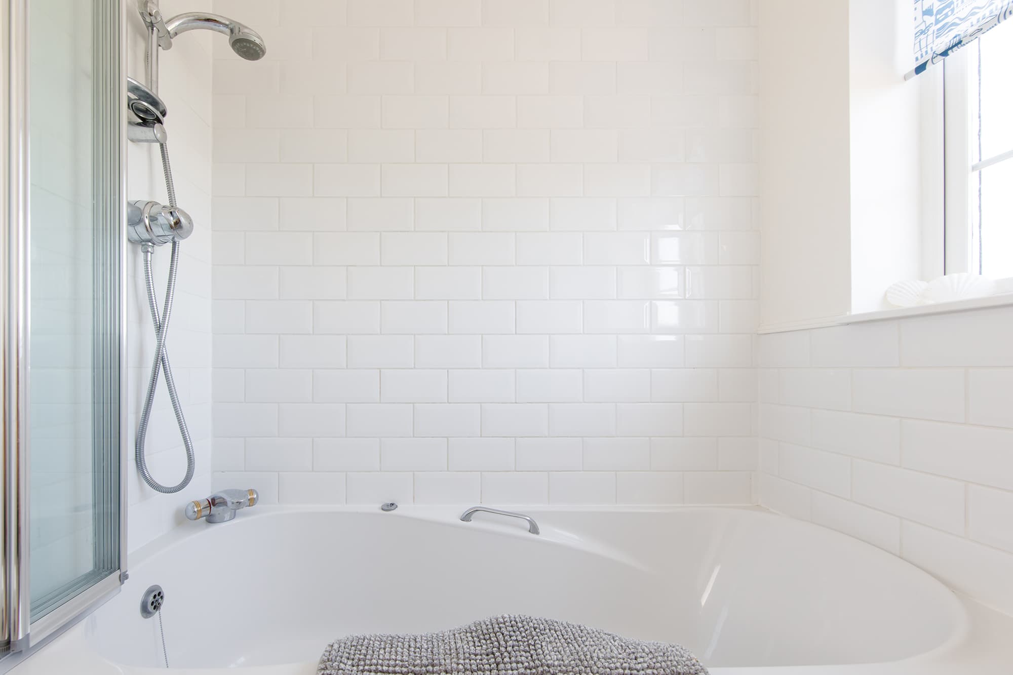 The family bathroom has a bath with overhead shower.