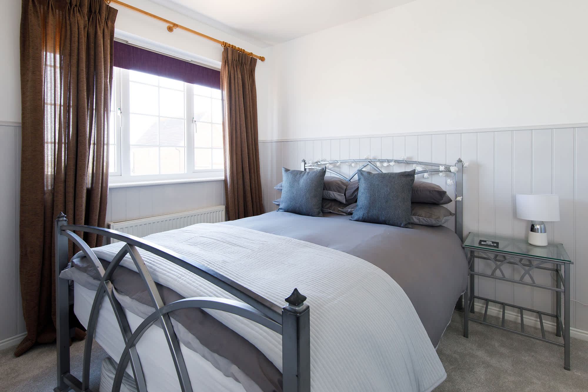 The second double room is beautifully furnished in sofa greys.