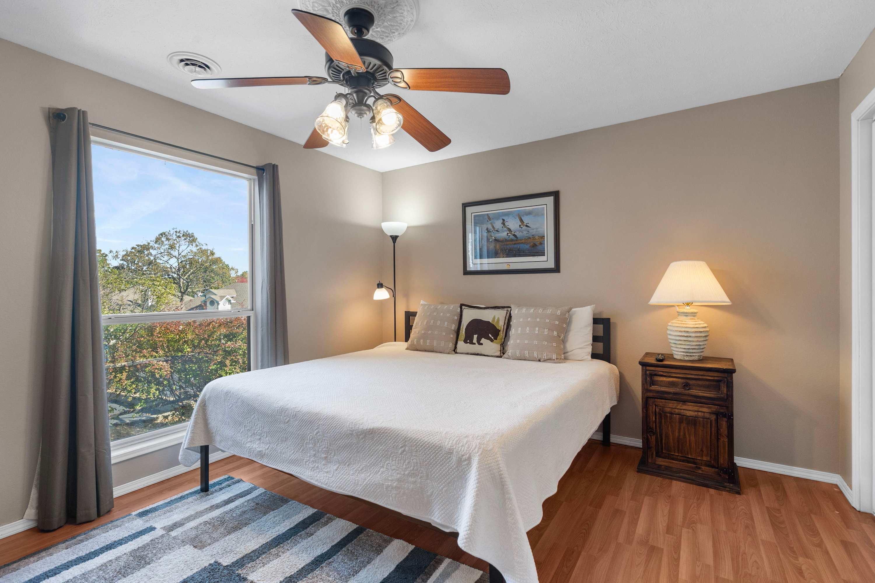 Recharge in the first bedroom, offering a plush king bed & TV​