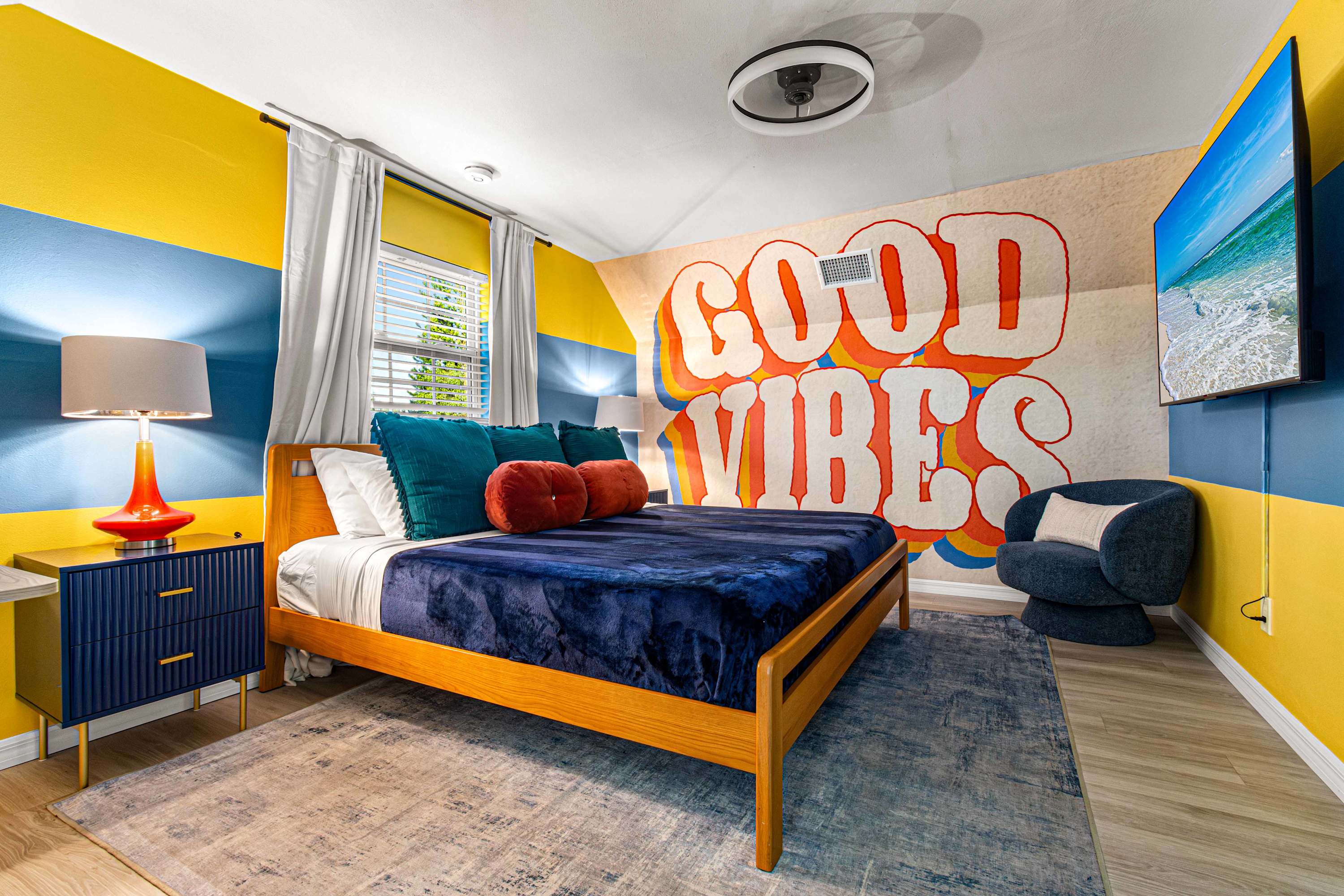Queen Bed Good Vibes Room Featuring TV