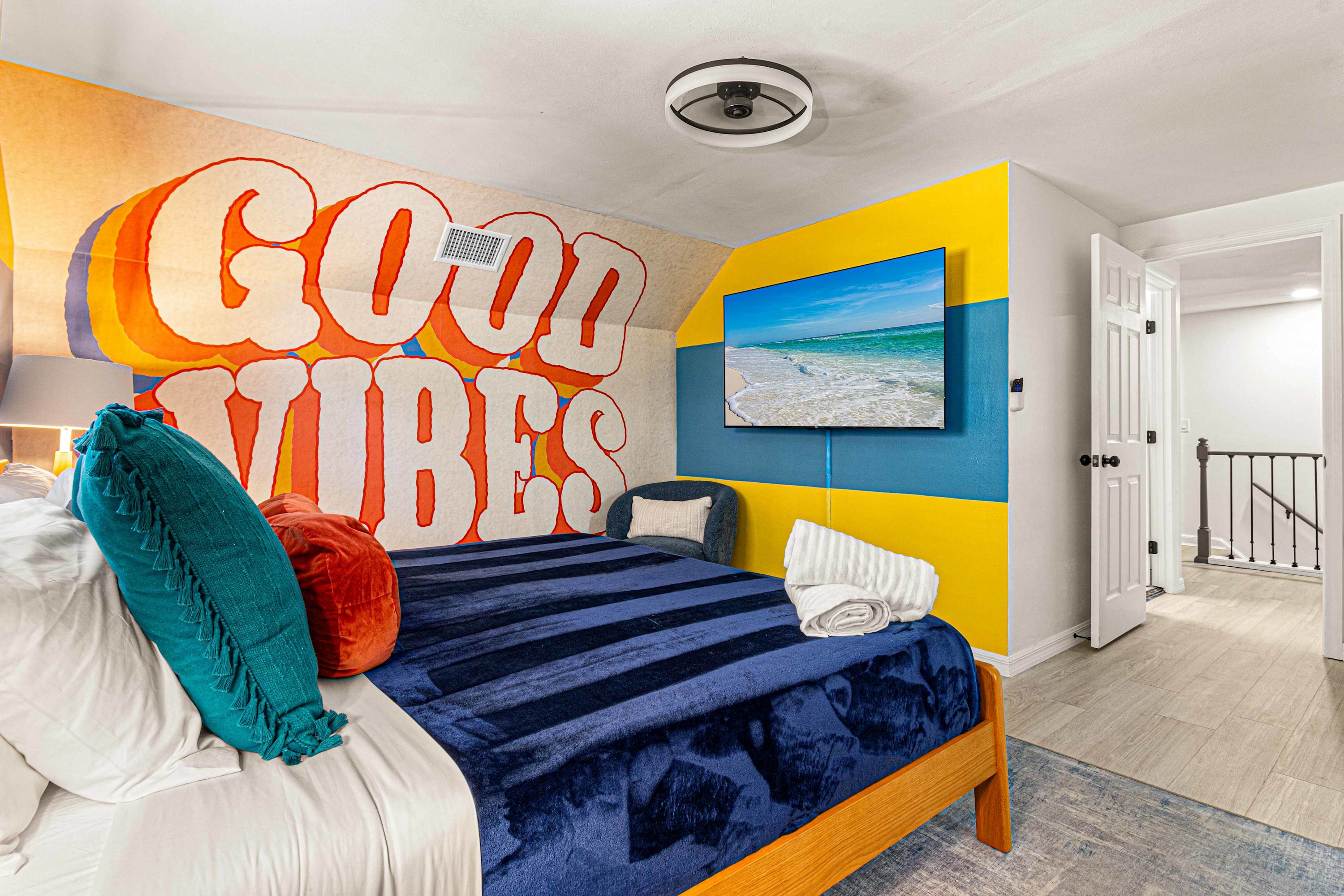 Queen Bed in Good Vibes room with TV