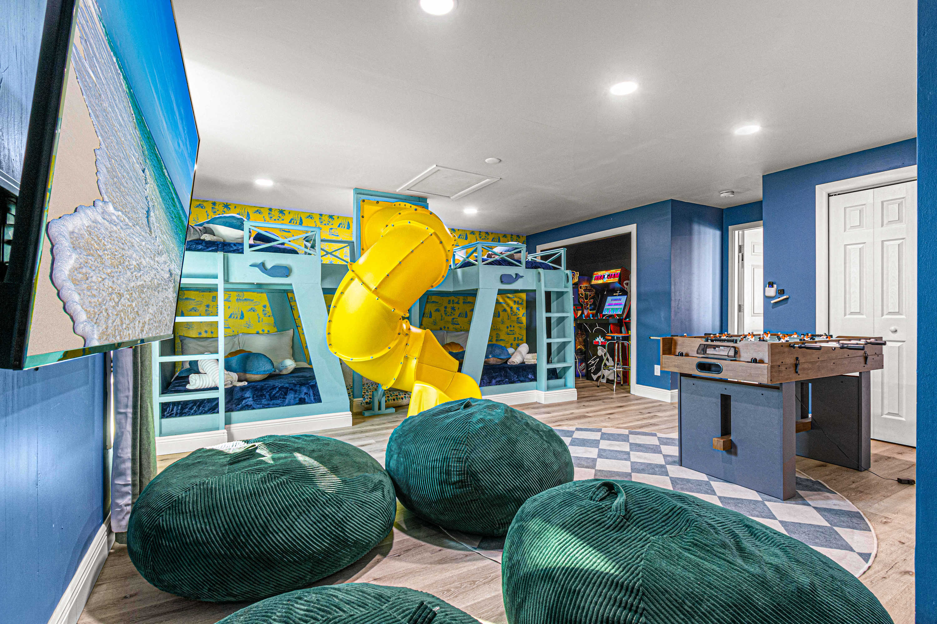 Kids' room amenities include a slide, TV, and foosball