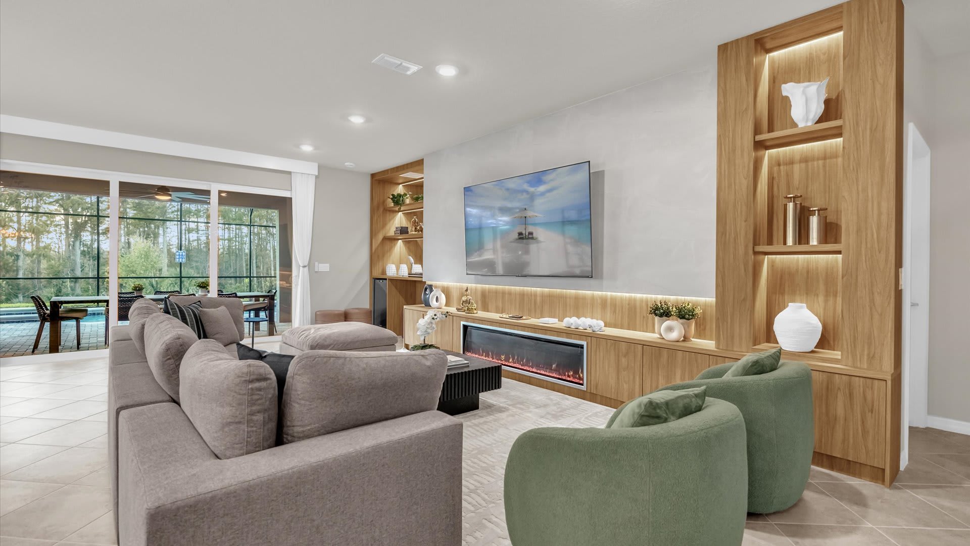 Bright family lounge with large sectional sofa and sliding doors opening to the patio.