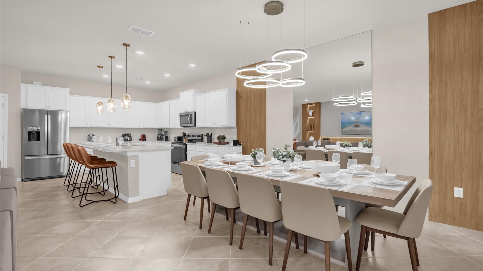 Elegant dining area with seating for 10 guests, a modern chandelier, and open access to the living space.