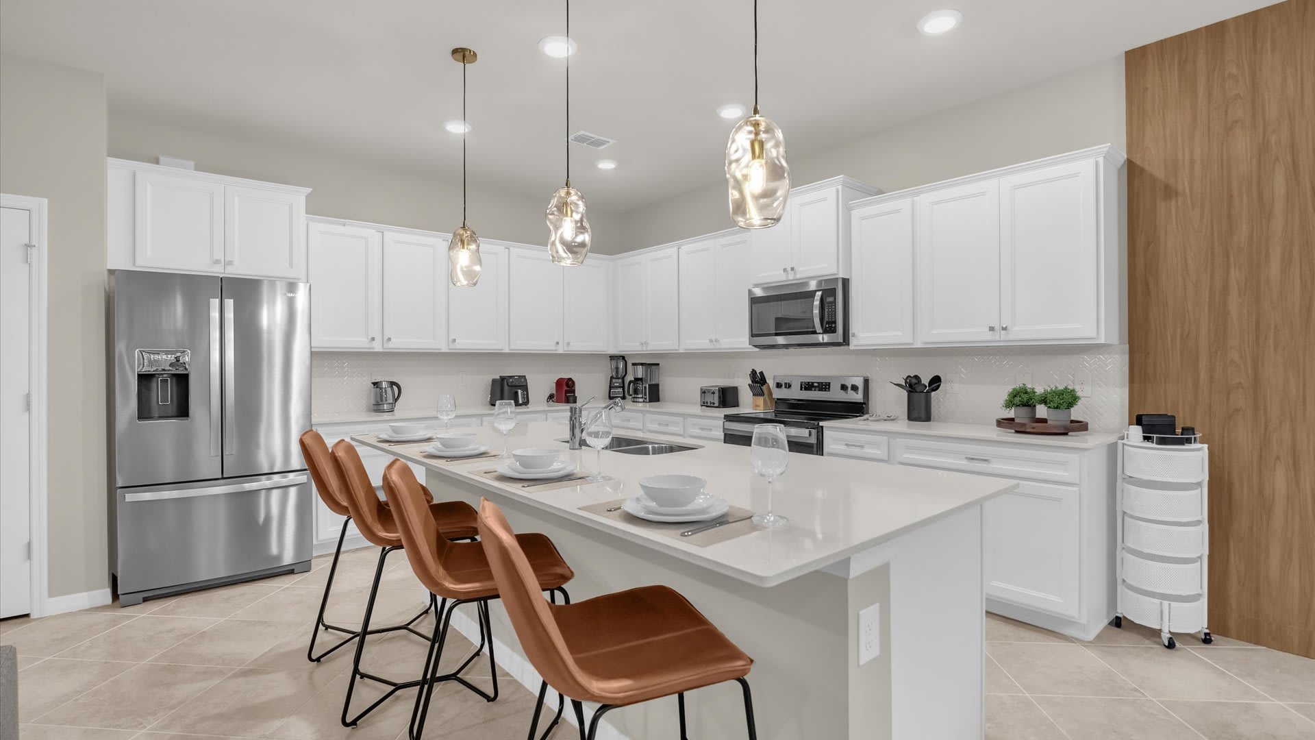 Contemporary kitchen with breakfast bar seating, modern appliances and sleek cabinetry.