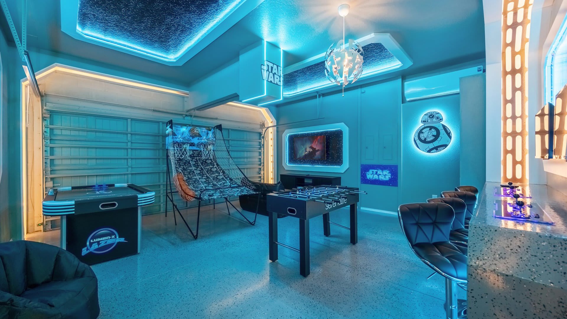 Vibrant game room with glowing neon lights, gaming consoles and table games for endless fun.