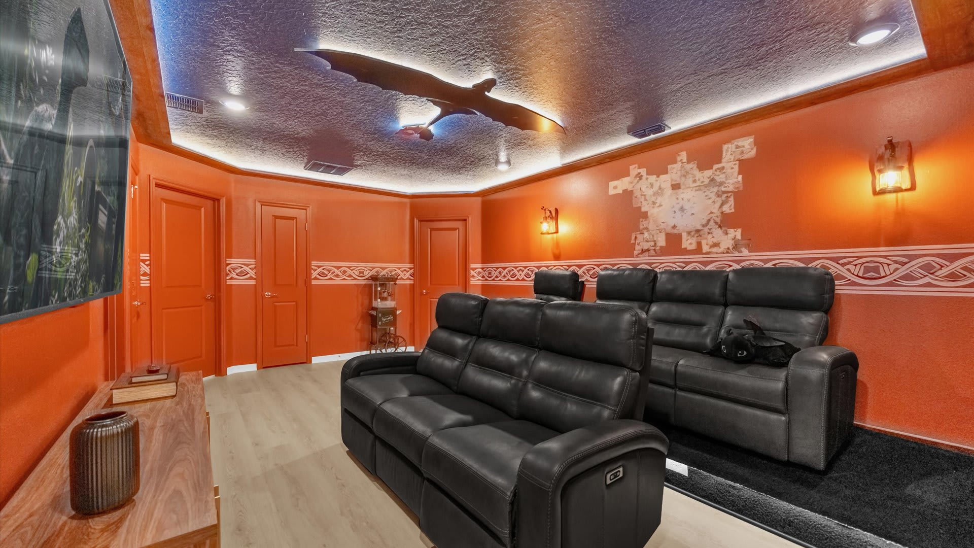 Home theatre room with plush recliners, large screen and LED lighting for the ultimate movie-night experience.