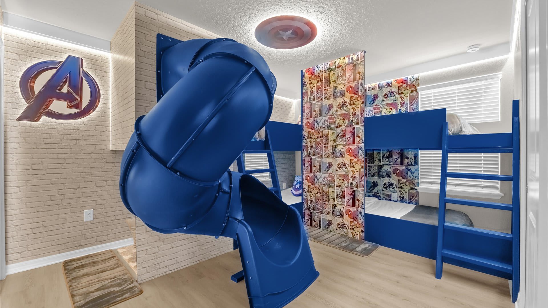 Marvel Avengers-themed bunk bedroom with slide and vibrant superhero graphics.