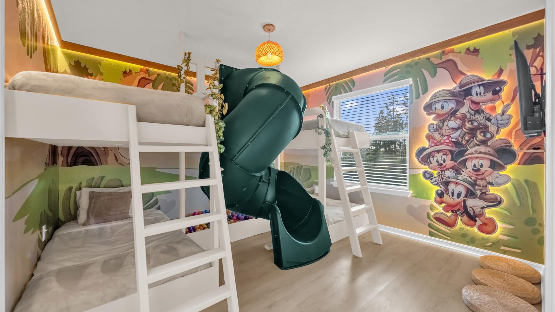Colourful kids’ bedroom featuring a spiral slide, themed bedding, and playful energy.
