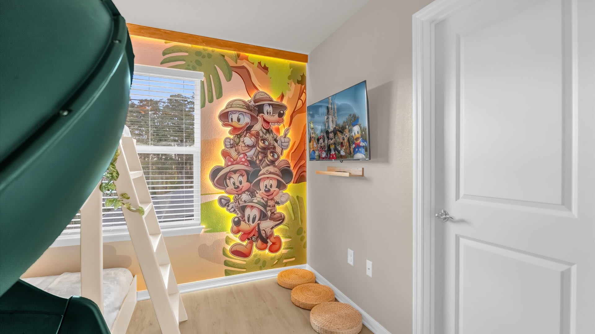 Colourful kids’ bedroom featuring a spiral slide, themed bedding, and playful energy.