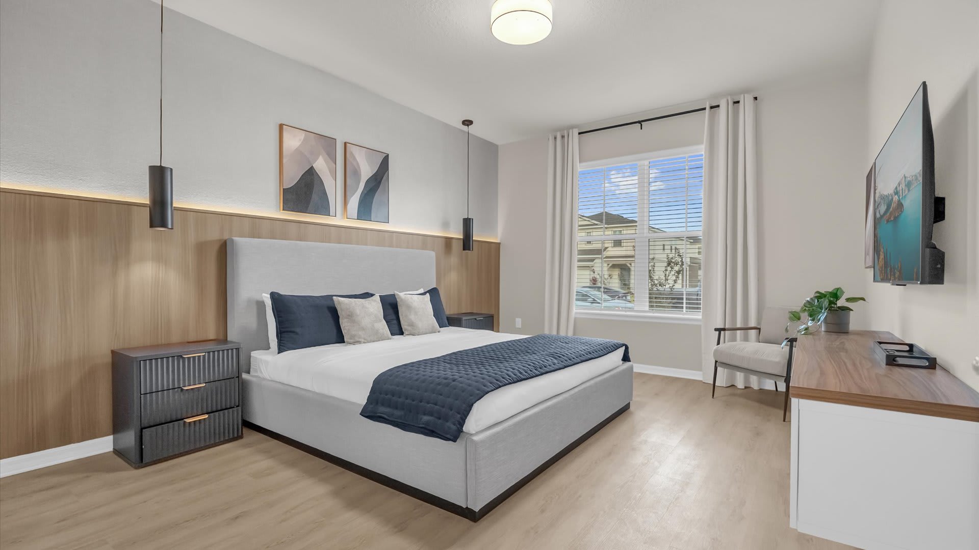 Spacious King Bedroom suite with contemporary decor and a smart TV