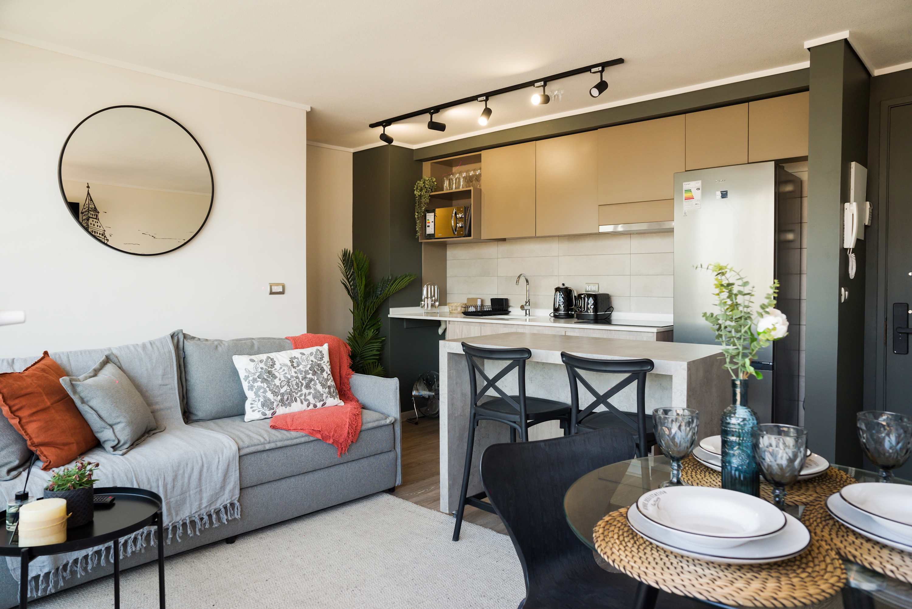 Cozy and stylish living space with a modern kitchen and dining area, perfect for relaxing or entertaining.