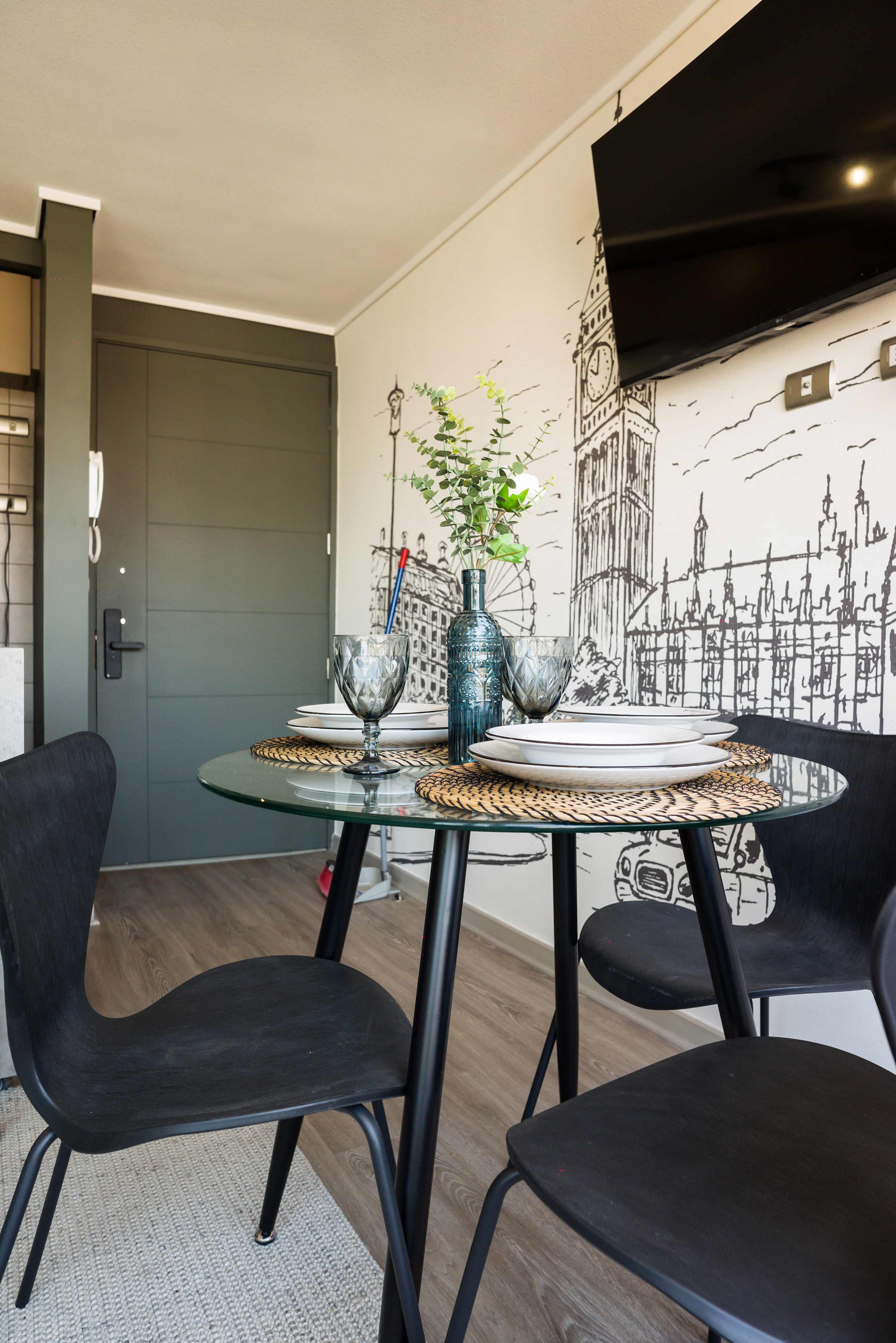 Chic dining area with a London-themed mural, perfect for cozy meals and relaxation.