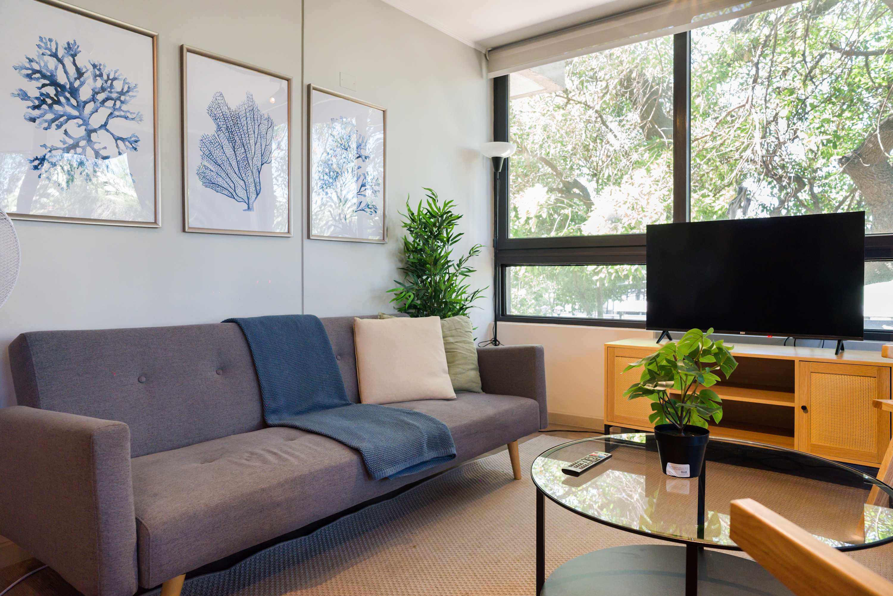 Enjoy the serene view from this stylish living room, featuring modern decor and a cozy sofa perfect for relaxation.
