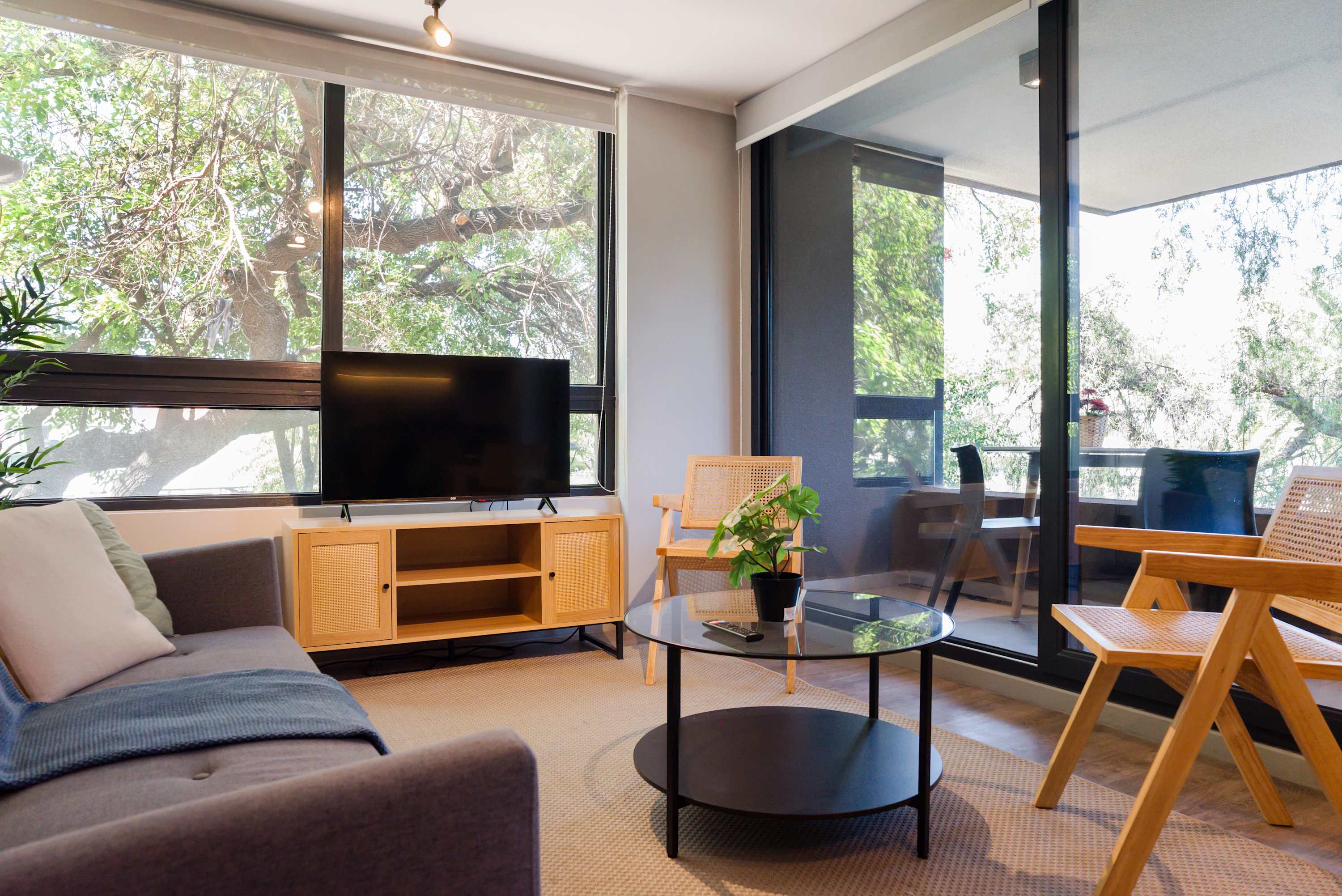 Unwind in this bright living room with lush views and modern decor, perfect for relaxation after exploring.