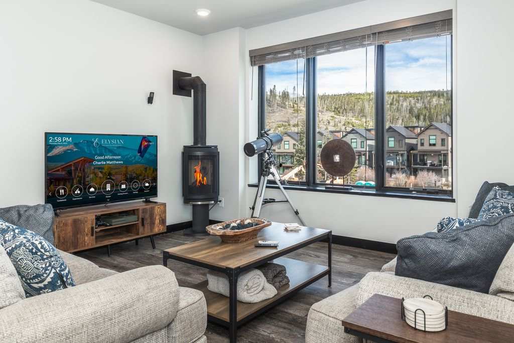Relax fireside in a cozy yet refined living space framed by sweeping mountain views and thoughtful, welcoming details.
