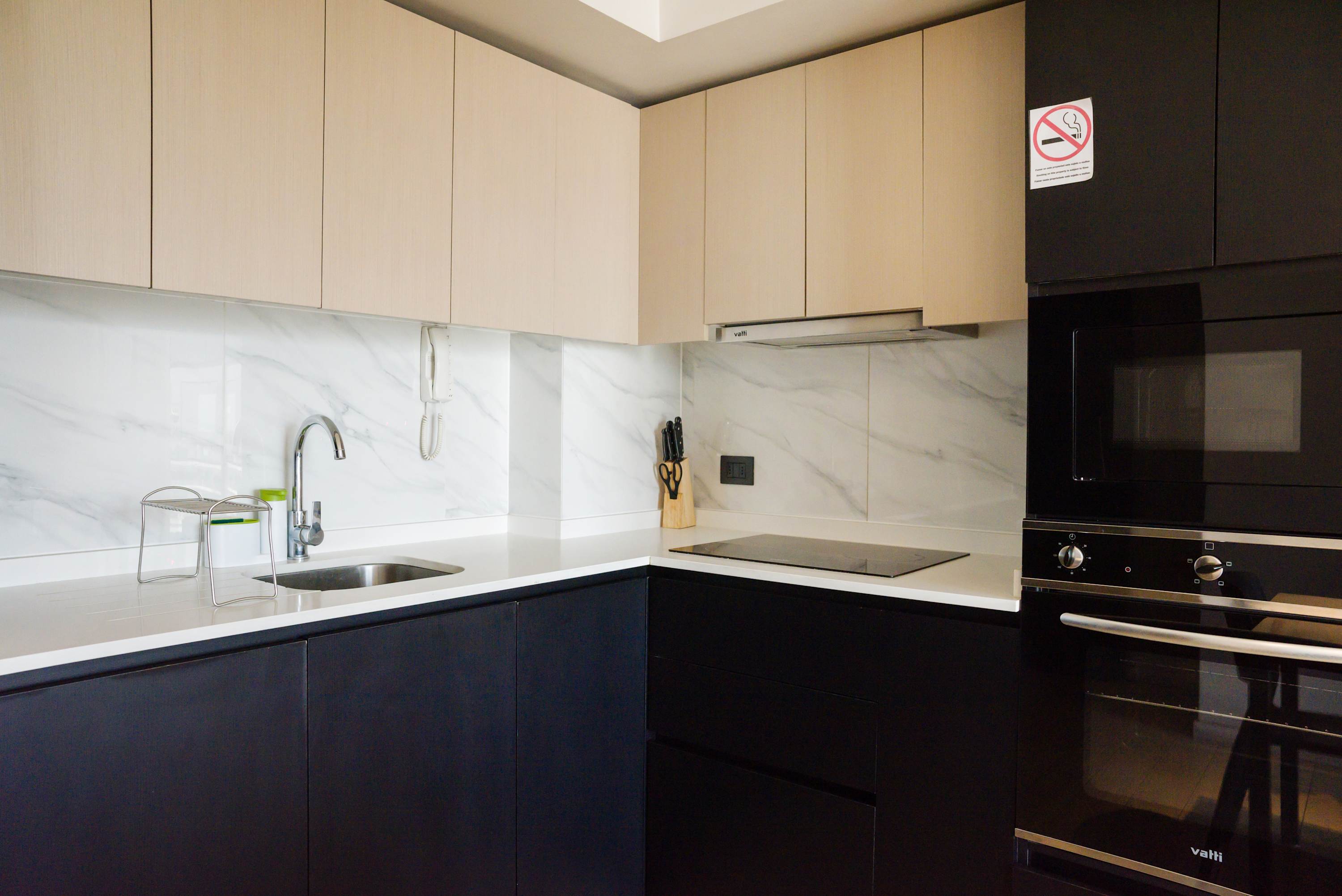 Sleek and modern kitchen with high-end appliances and ample counter space, perfect for cooking enthusiasts.