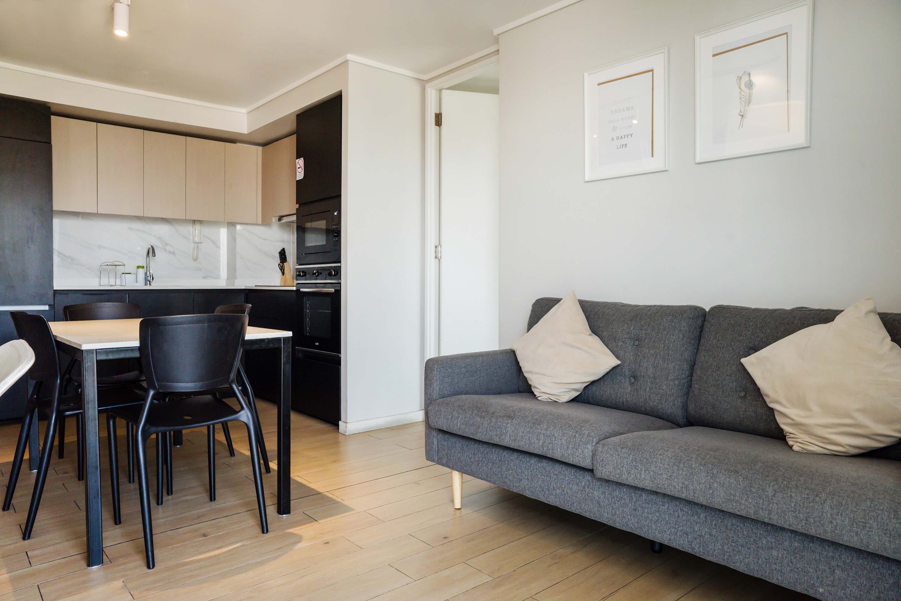 Cozy living area with modern kitchen, perfect for relaxing after exploring the city.