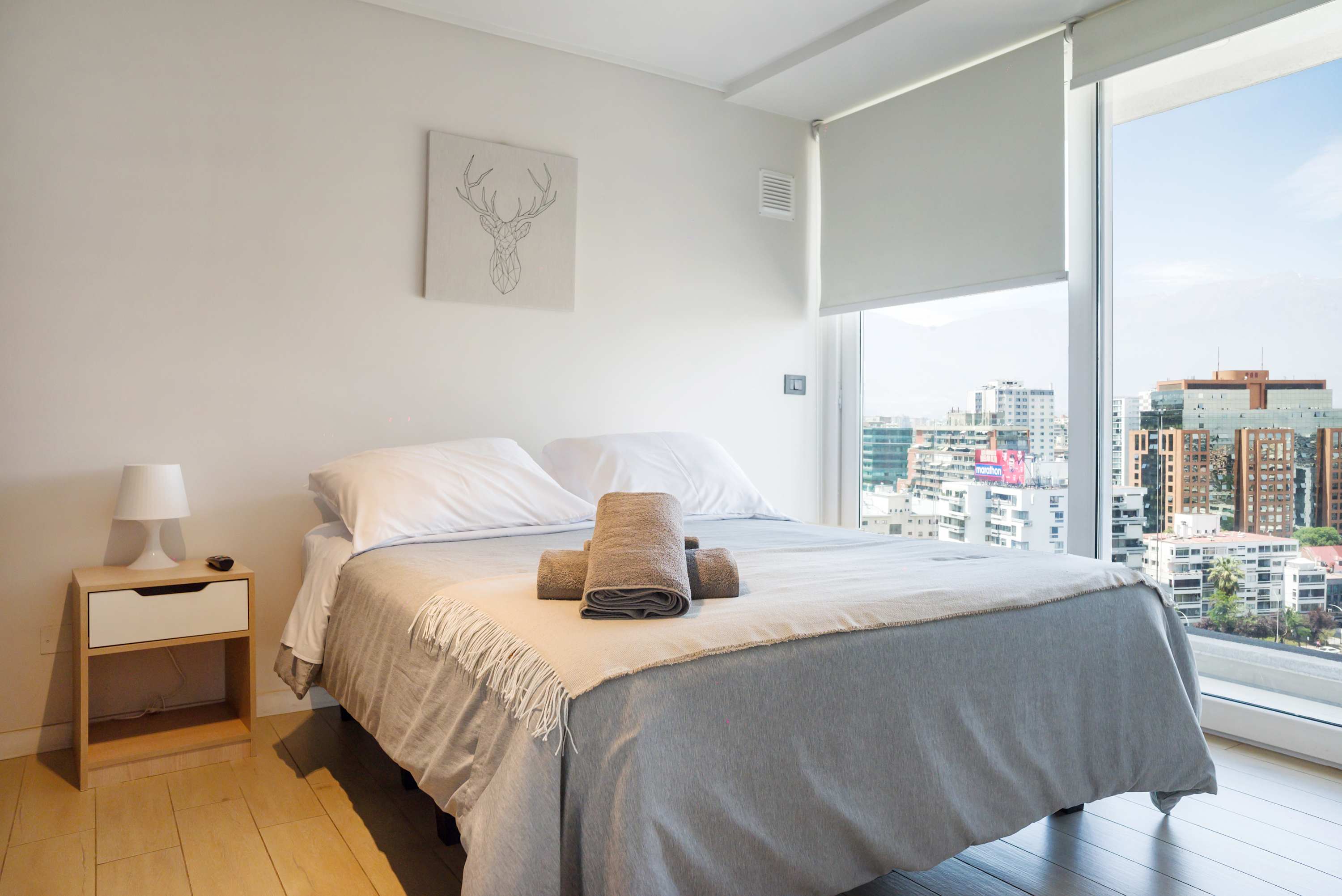 Cozy bedroom with stunning city views, perfect for a relaxing stay.
