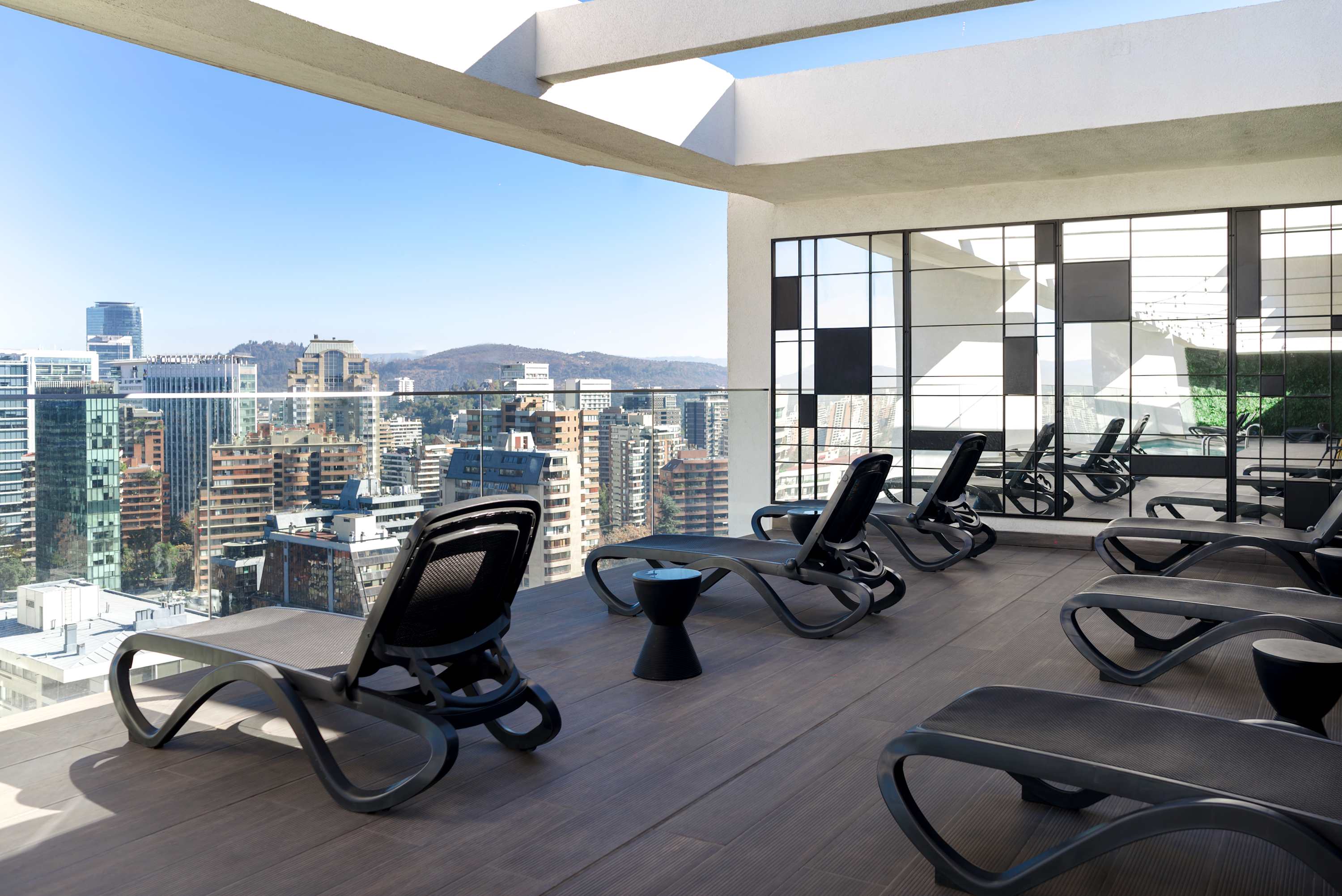 Enjoy a refreshing swim and relax in style at this chic rooftop pool with stunning city views.
