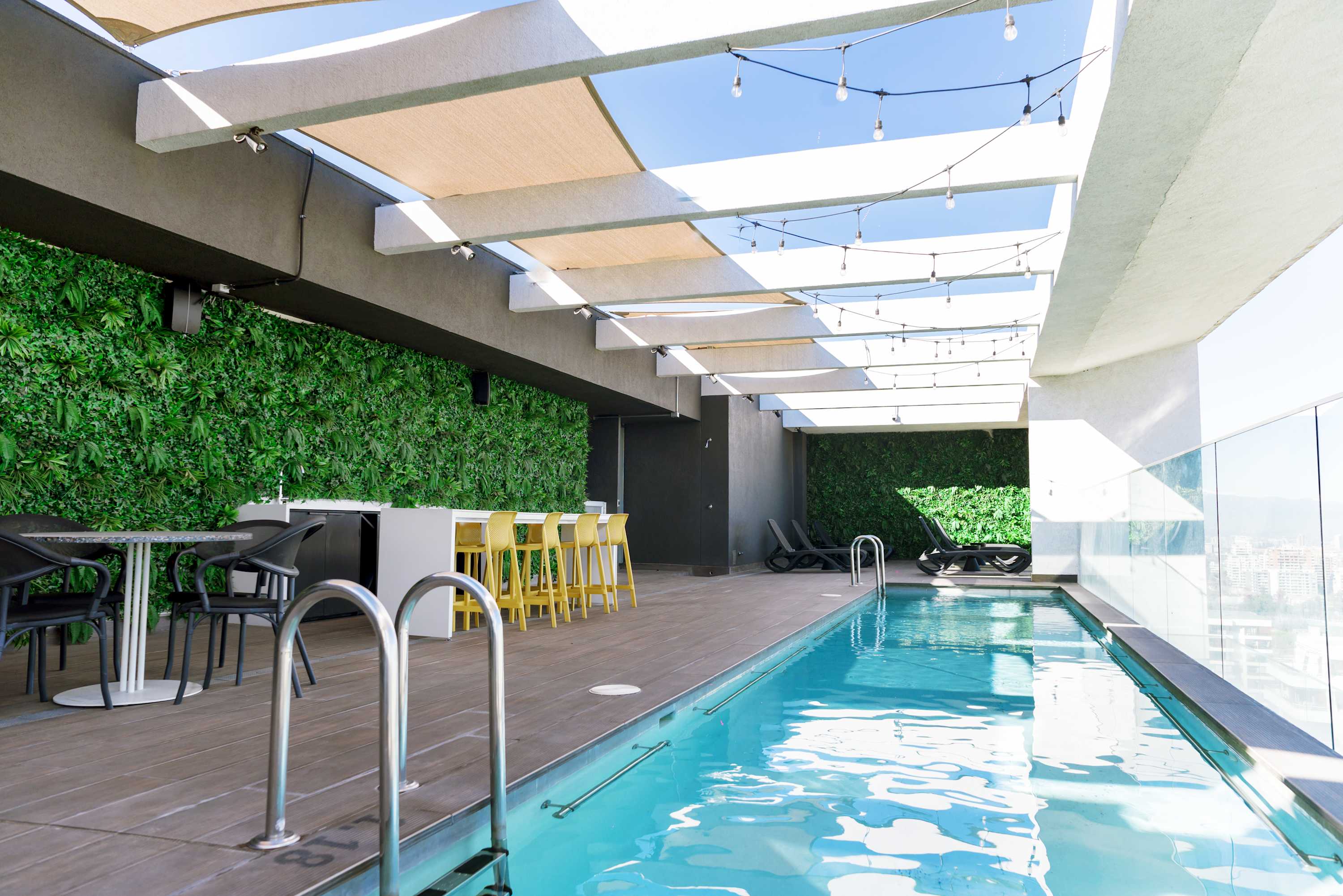 Enjoy a refreshing swim and relax in style at this chic rooftop pool with stunning city views.
