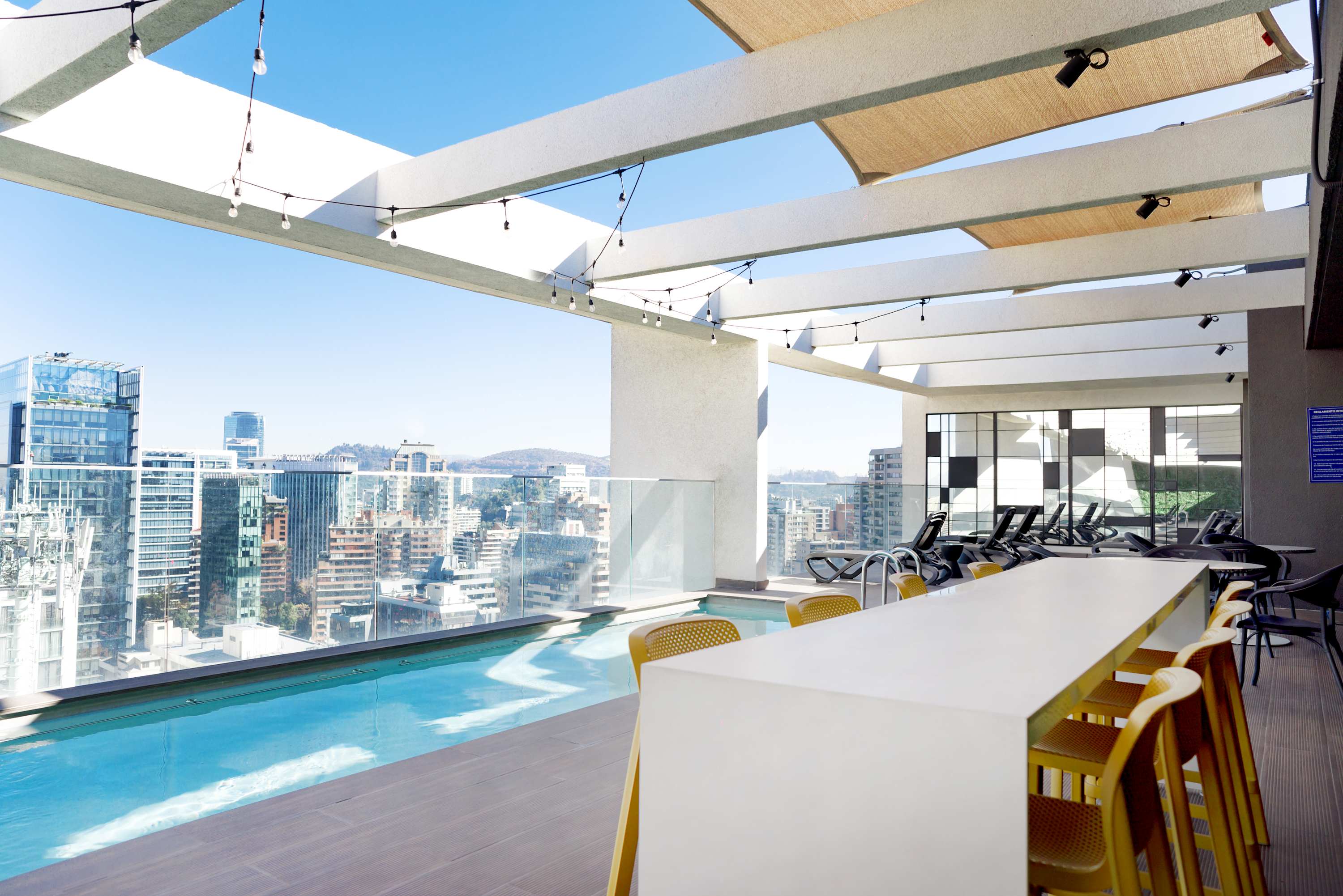 Enjoy a refreshing swim and relax in style at this chic rooftop pool with stunning city views.
