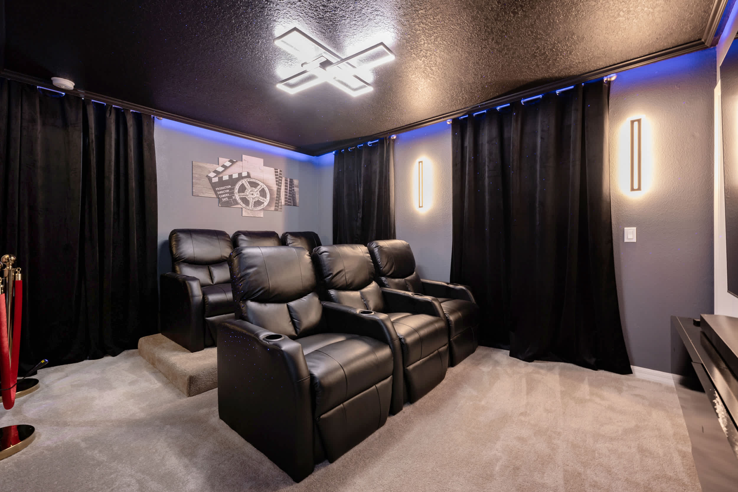 Experience cinematic luxury in your private home theater with plush recliners and ambient lighting.