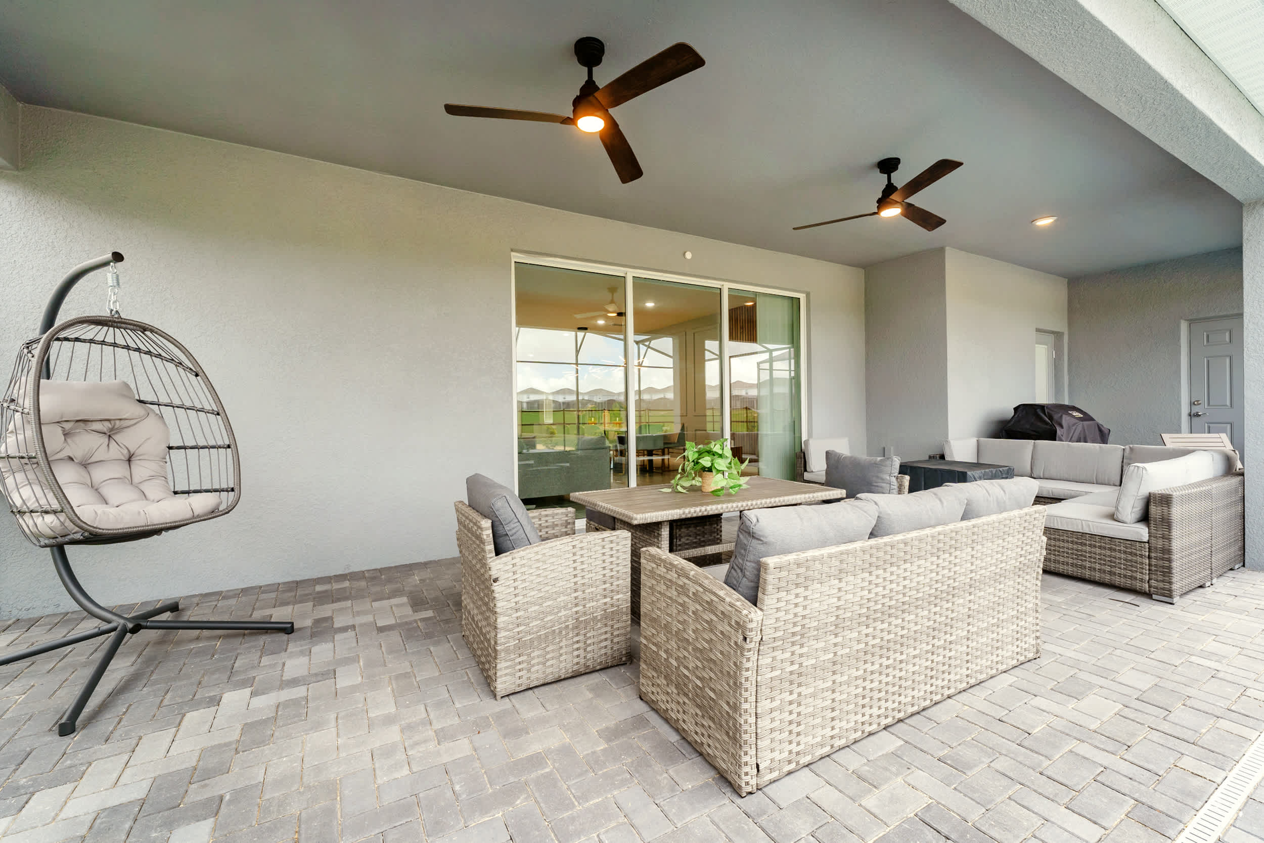 Relax on the spacious patio with cozy seating and a grill, perfect for outdoor gatherings.