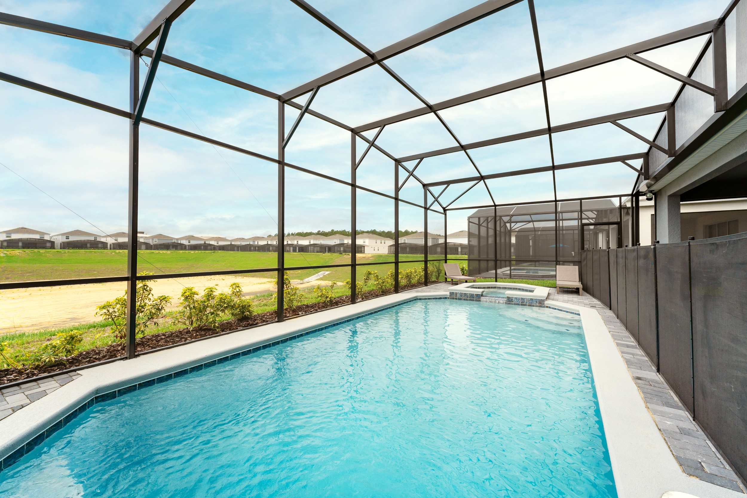Relax in your private screened pool oasis, perfect for unwinding and enjoying the serene views.
