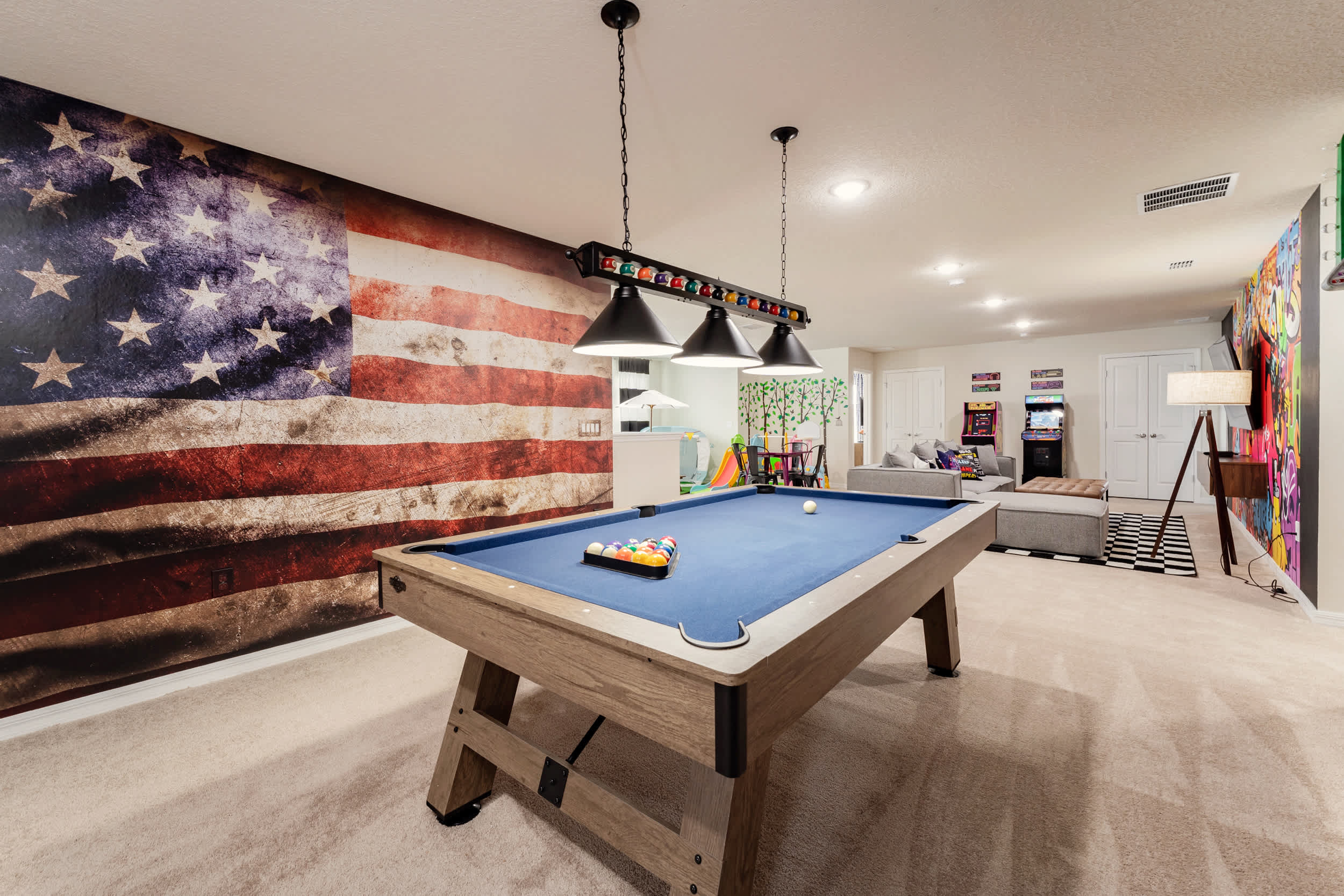 Enjoy endless fun in this vibrant game room with a pool table, arcade games, and cozy seating. Perfect for entertainment and relaxation!