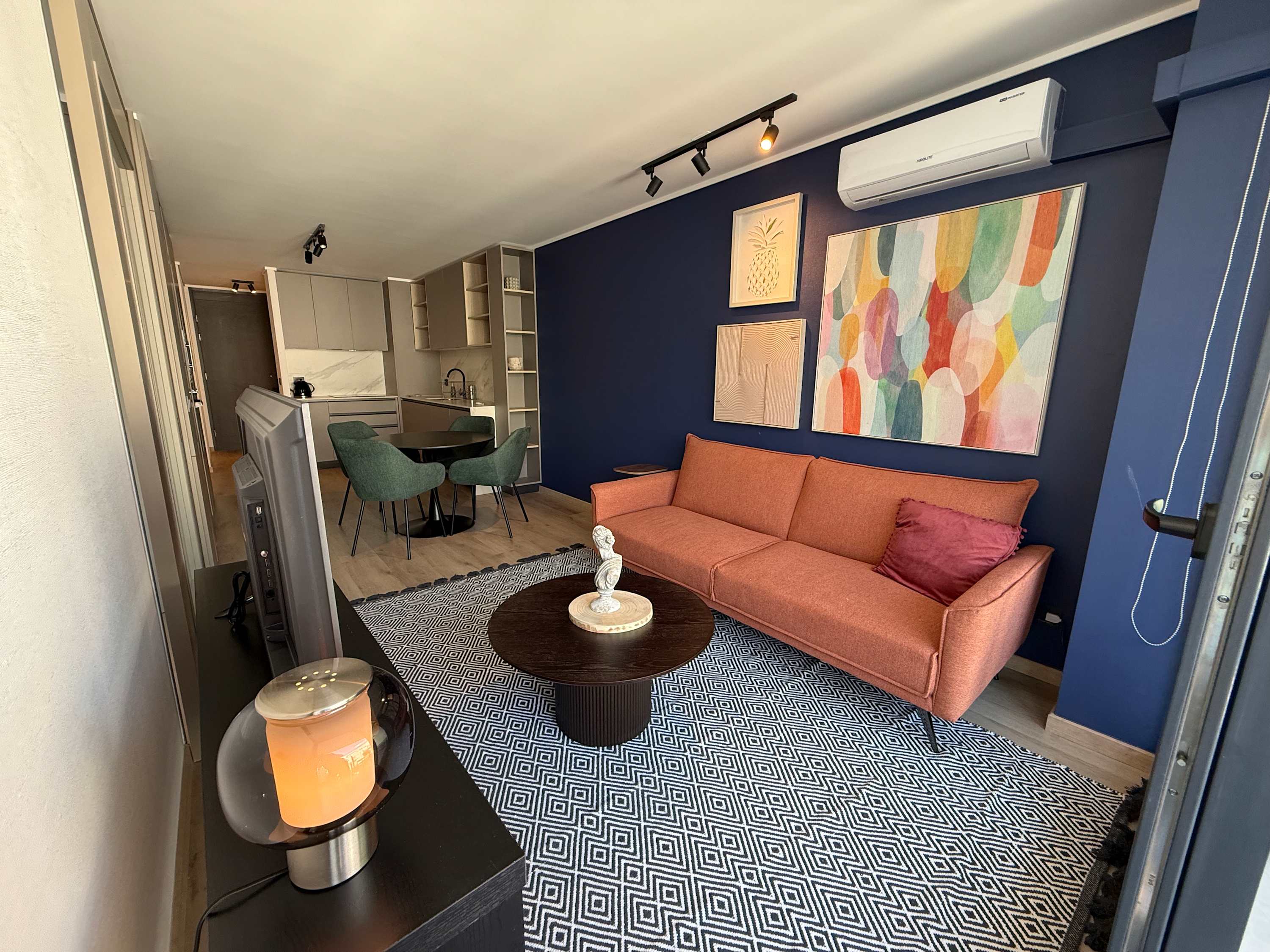 Stylish living area with vibrant decor and cozy seating, perfect for relaxation and entertainment.