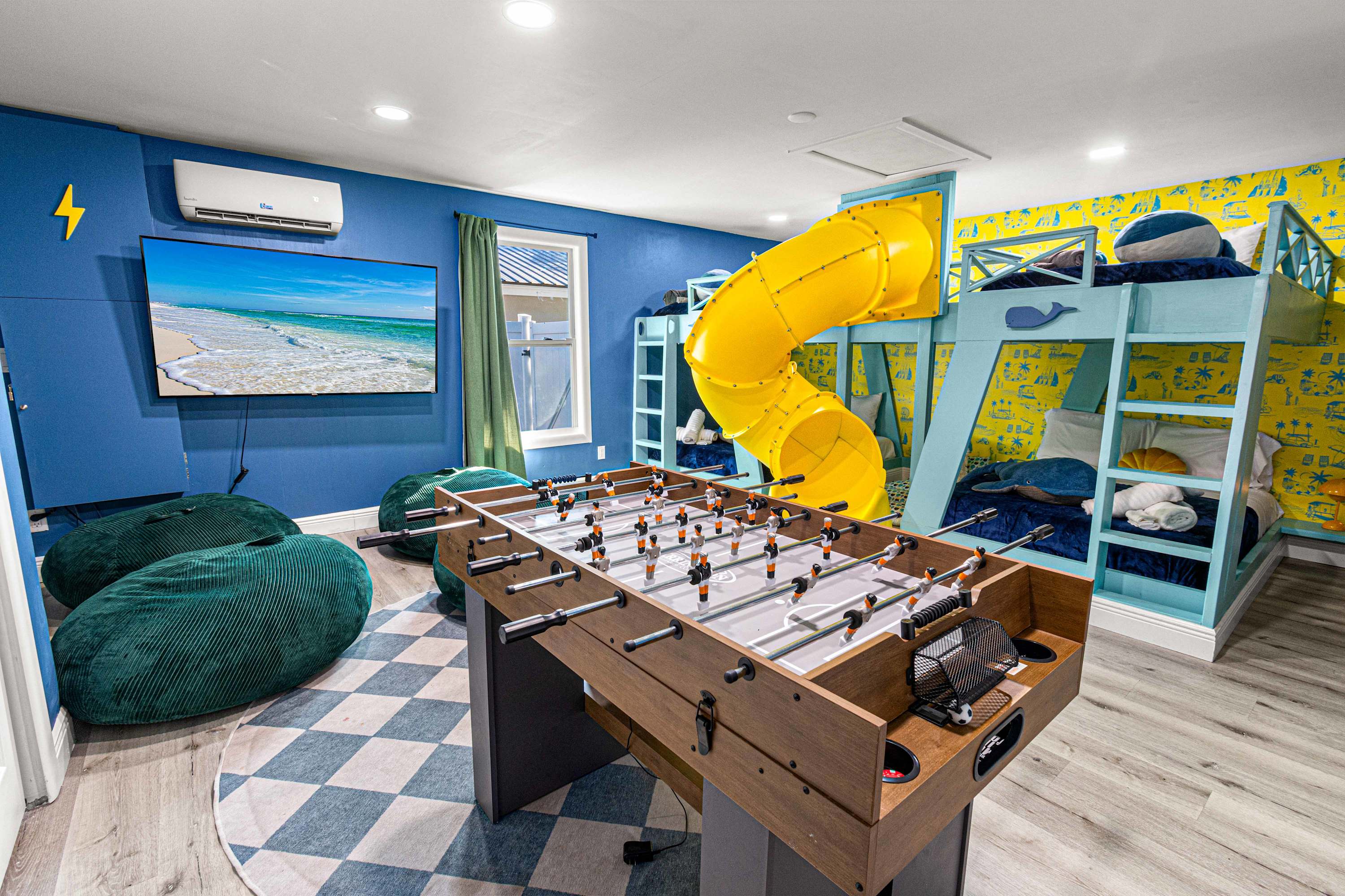 Kids' bedroom with a slide and a foosball table