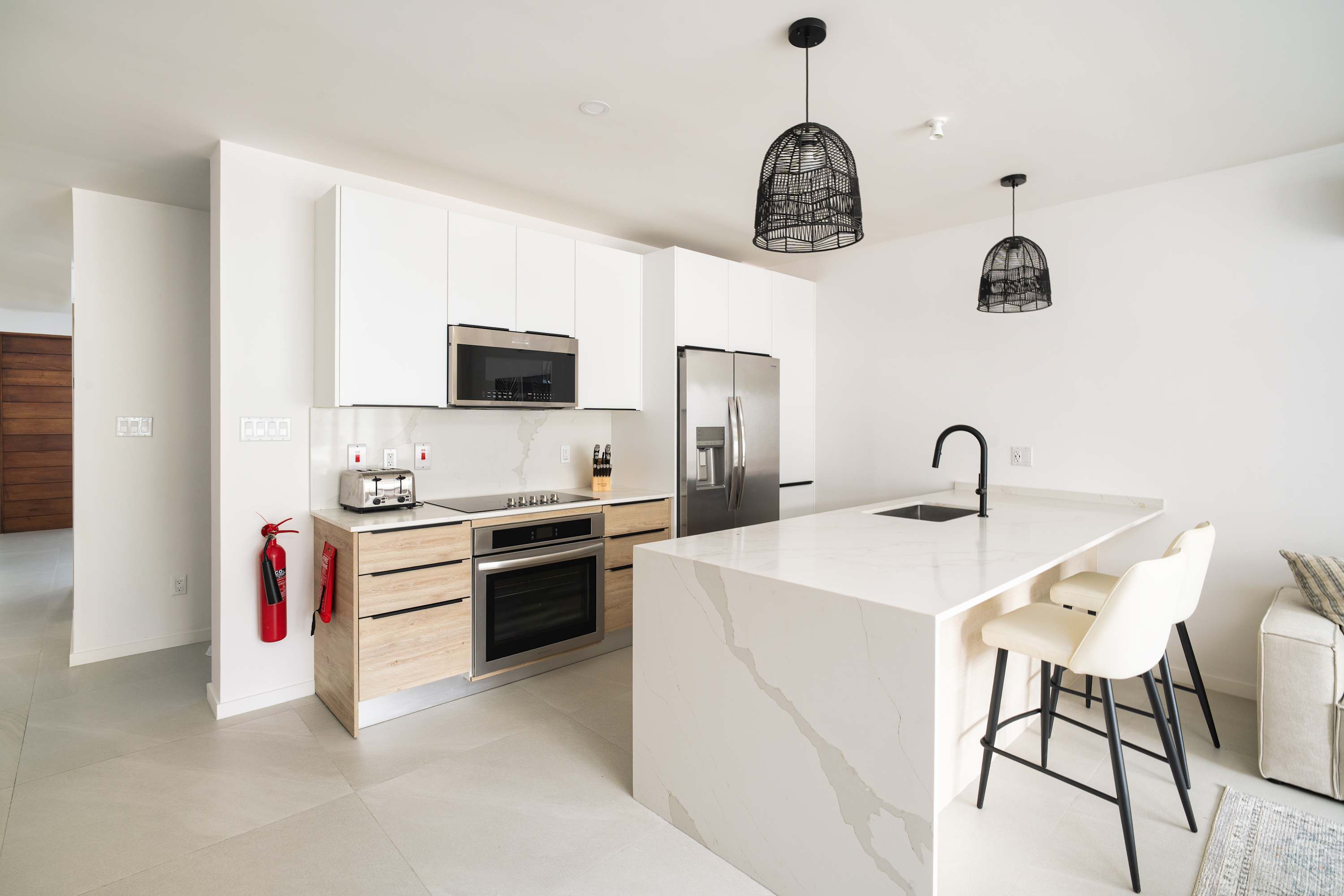Kitchen: Open-concept living area with modern Caribbean flair, perfect for gatherings