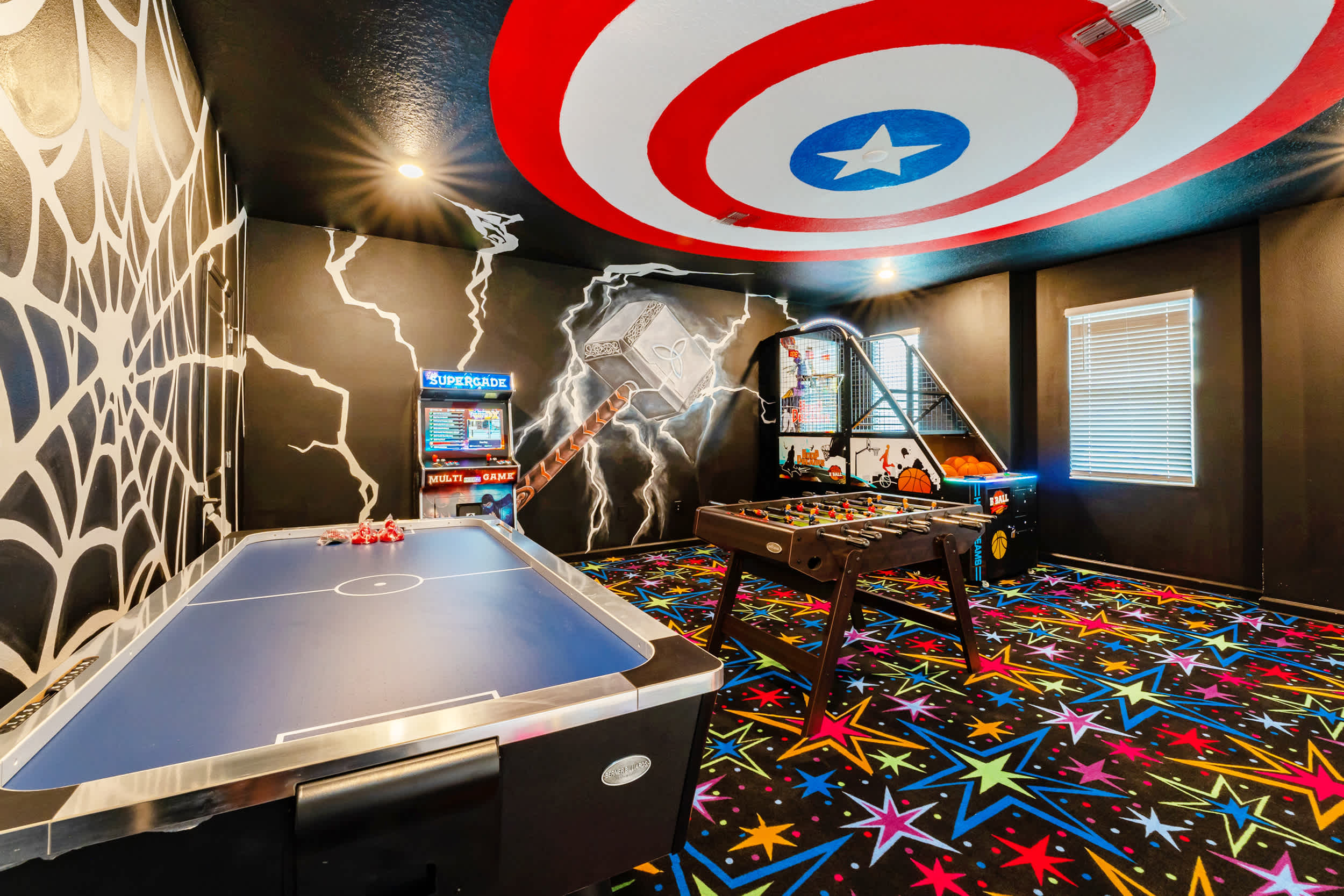 Unleash your inner hero in this vibrant game room, complete with air hockey, foosball, and arcade games for endless fun.